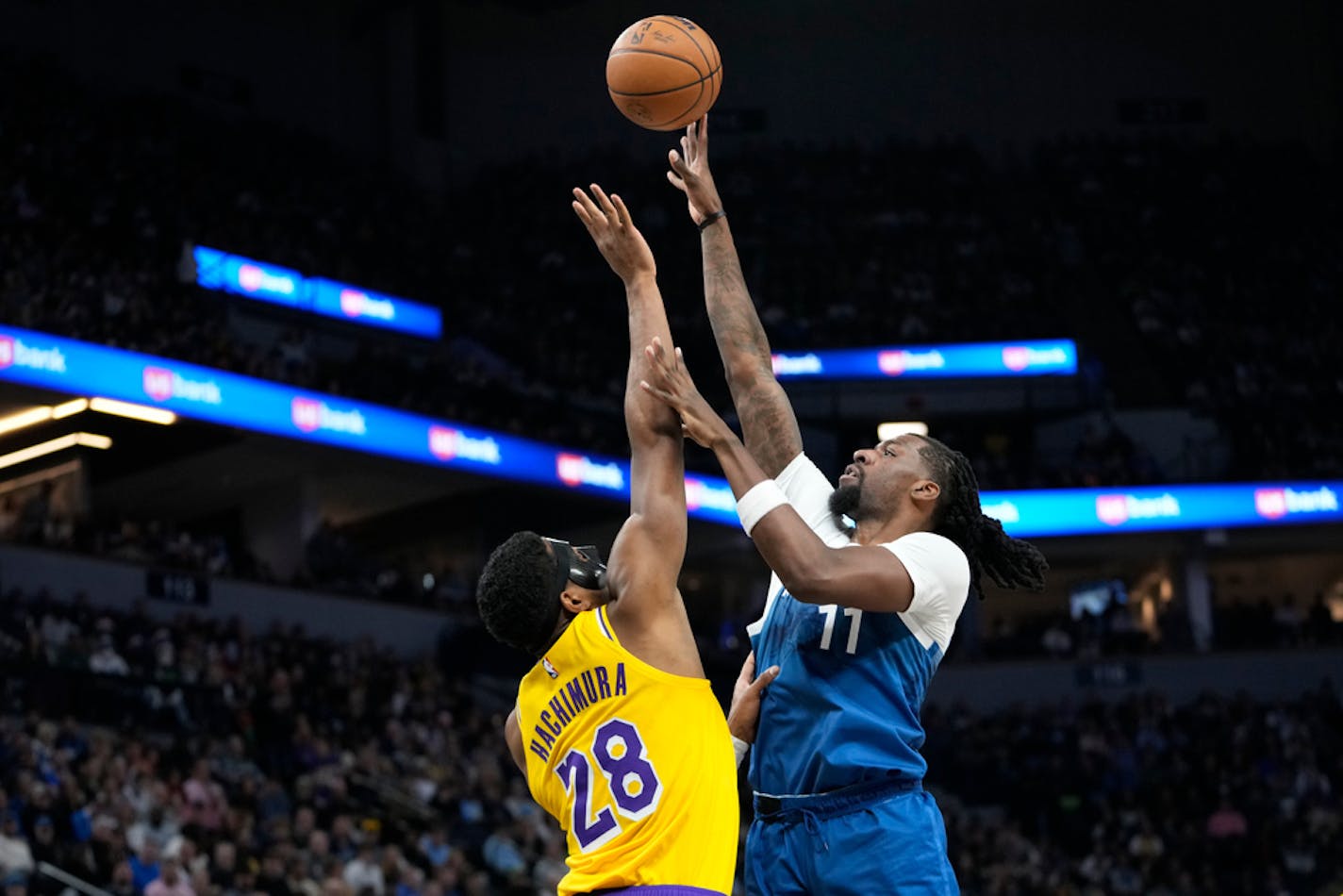 Minnesota Timberwolves center Naz Reid (11) shoots as Los Angeles Lakers forward Rui Hachimura (28) defends during the first half of an NBA basketball game Thursday, Dec. 21, 2023, in Minneapolis. (AP Photo/Abbie Parr)