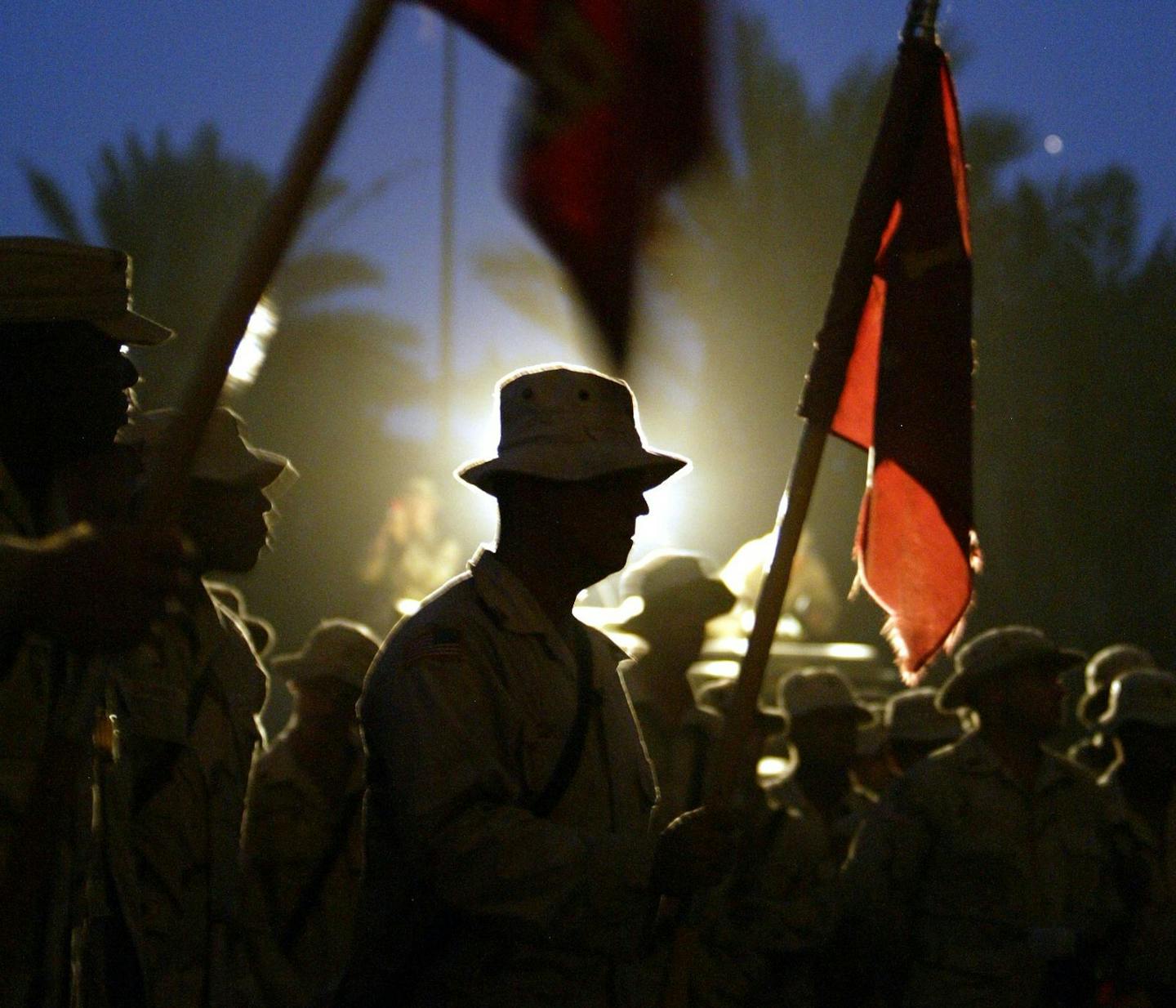 Soldiers with the Fourth Battalion, First Field Artillery from Fort Riley, Kan., stood in silence during a Sept. 11 commemorative service at the units forward operating base at Al-Sa&#x2019;lam Palace in Baghdad in 2003.