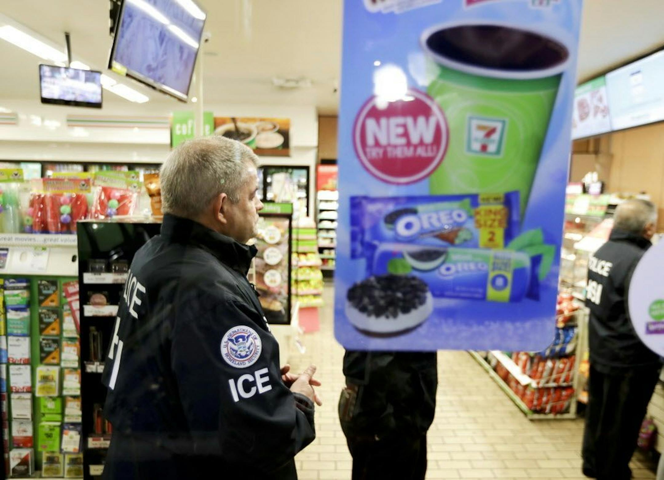 U.S. Immigration and Customs Enforcement agents serve an employment audit notice at a 7-Eleven convenience store Wednesday, Jan. 10, 2018, in Los Angeles. Agents said they targeted about 100 7-Eleven stores nationwide Wednesday to open employment audits and interview workers.