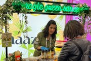 Fatima Sajady, the inspiration for St. Paul-based Maazah sauces and dips, talks to an attendee at Expo West in Anaheim, Calif., in March. As Maazah an