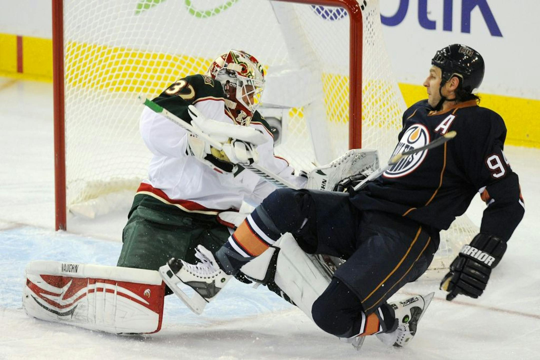 Edmonton's Ryan Smyth fell over Wild goalie Niklas Backstrom during the first period of Minnesota's 2-1 shootout victory Thursday.