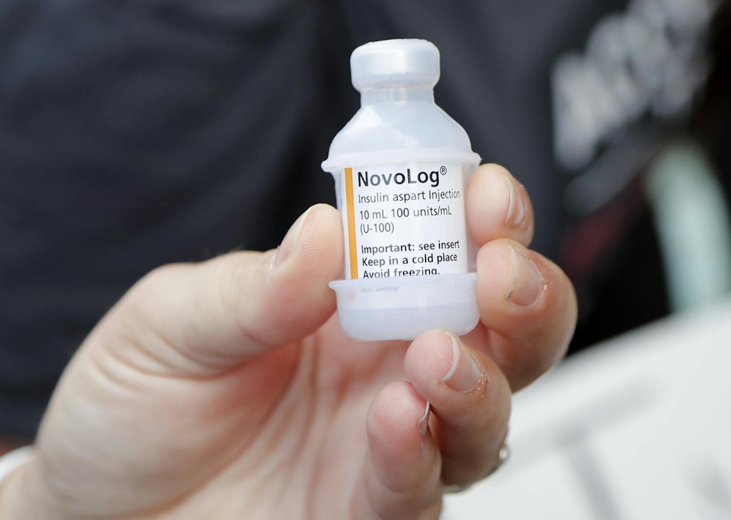 A patient holds a vial of insulin during a news conference outside the Olde Walkersville Pharmacy, Sunday, July 28, 2019, in Windsor, Ont. Democratic presidential candidate, Sen. Bernie Sanders, I-Vt., and a busload of insulin patients stopped in Windsor to purchase the drug to highlight the high costs of the insulin in the United States. (AP Photo/Carlos Osorio) ORG XMIT: MICO109