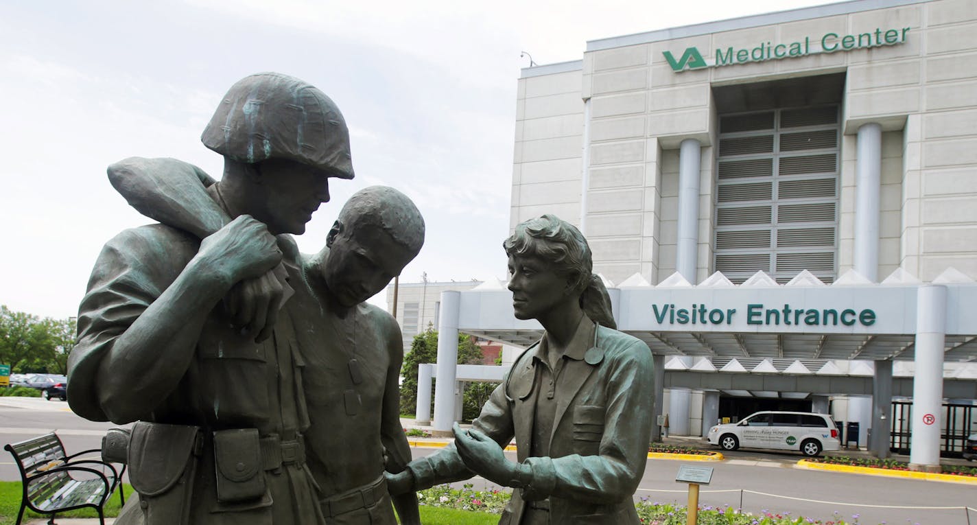 Three statues portraying a wounded soldier being helped, stand on the grounds of the Minneapolis VA Hospital, Monday, June 9, 2014. An audit of 731 VA hospitals and clinics found that a 14-day goal for seeing first-time patients was unattainable given increasing demand for health care. The VA said Monday it was abandoning the scheduling goal. (AP Photo/Jim Mone) ORG XMIT: MP101