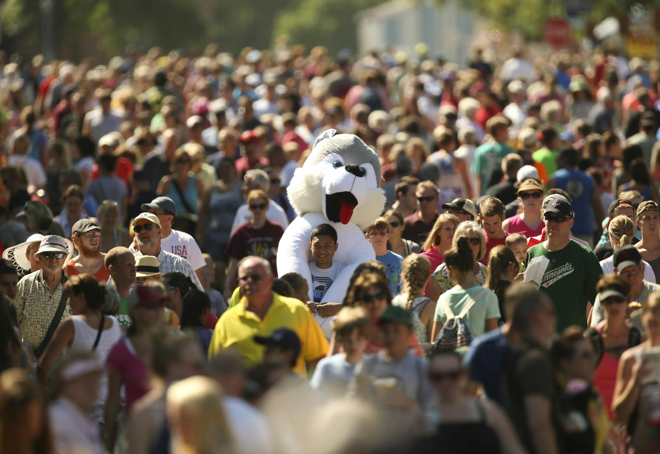 The Minnesota State Fair opened Thursday, August 22, 2013 on a perfect day, weather-wise. Ravem Noguerraza of Coon Rapids didn't even win the giant stuffed dog - one of his friends did - but he was willing to lug it along as he walked up Judson Ave. Thursday afternoon. ] JEFF WHEELER ‚Ä¢ jeff.wheeler@startribune.com ORG XMIT: MIN1308221553065647