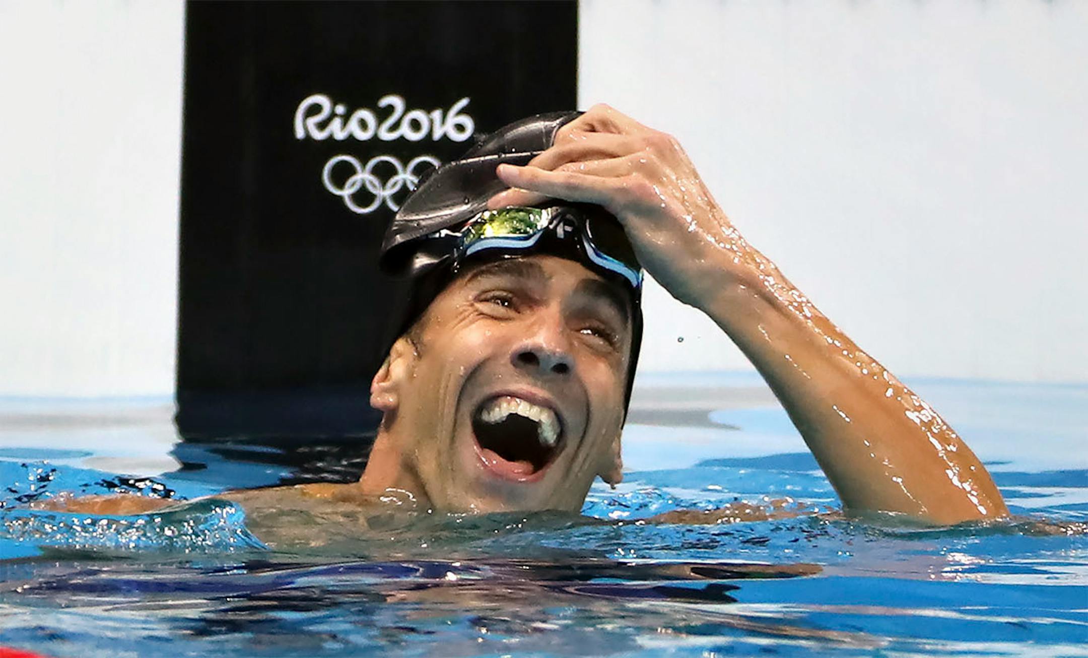 Michael Phelps reacts to winning a three way tie for silver in the 100 meter butterfly.