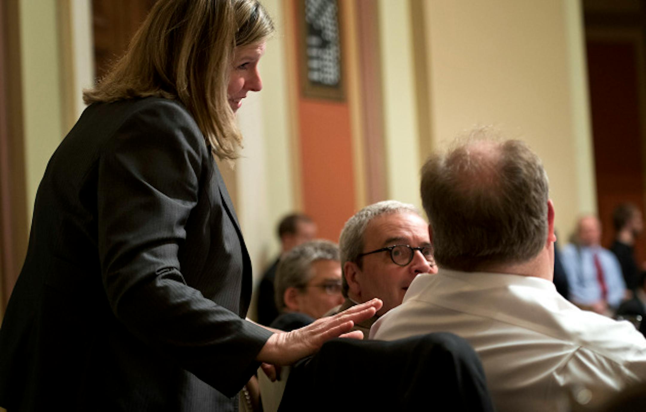 Ann Lenczewski, DFL-Bloomington, chair of the House tax committee paid a surprise visit to the bills chief opponent Rep. Greg Davids, R-Preston,  during House debate of the tax bill.  Wednesday, April 24, 2013    ]       GLEN STUBBE * gstubbe@startribune.com