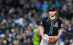 Diamondbacks starting pitcher Brandon Pfaadt reacts after throwing a wild pitch in Seattle on Sunday.