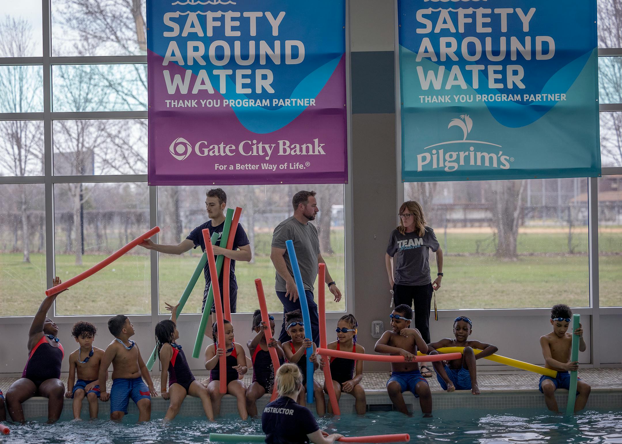 Madison Elementary second-graders get pool noodles to help them learn how to swim.