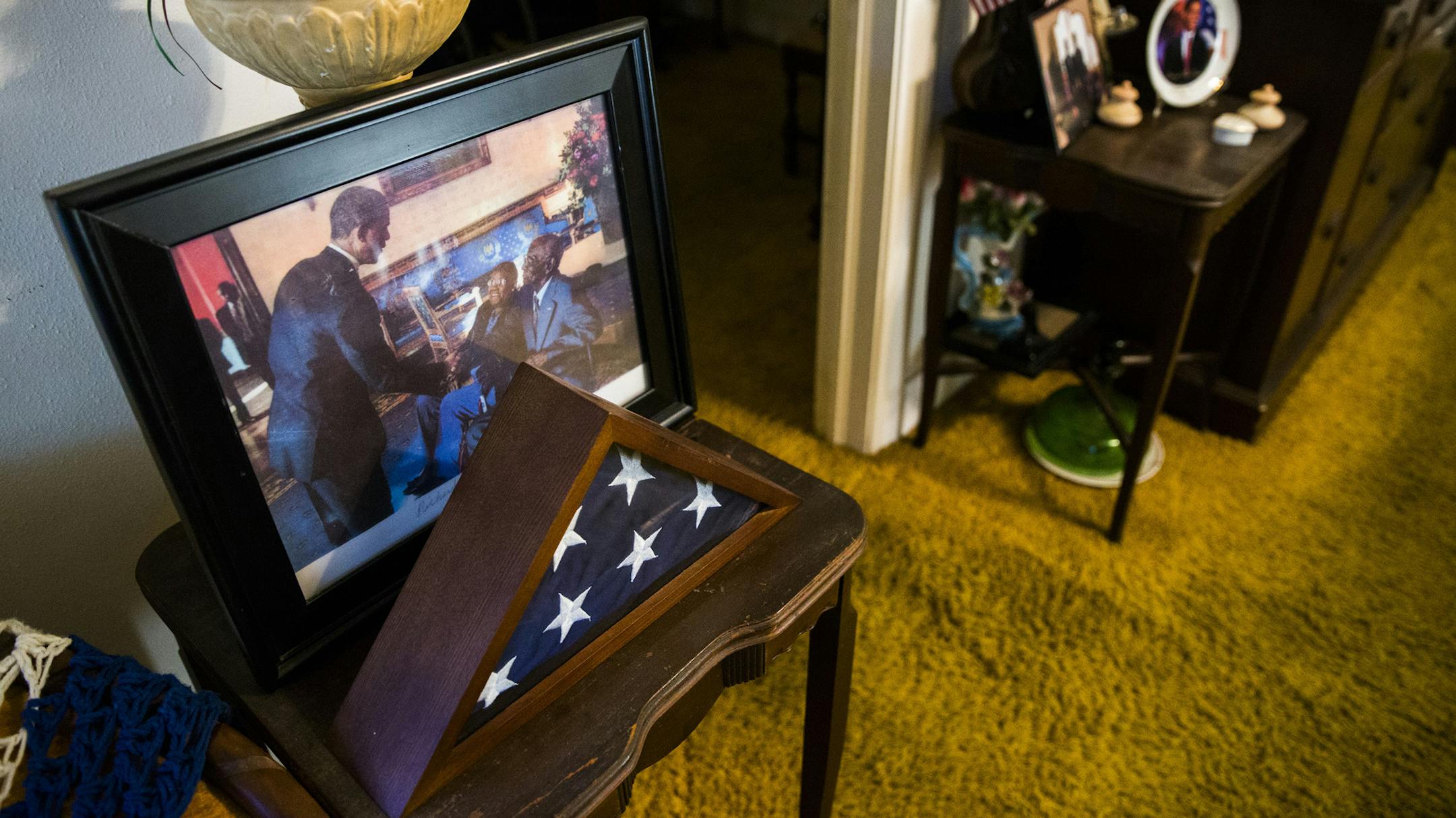 A photograph of former president Barack Obama with Richard Overton, 111, is displayed among American flags and other mementos in Overton's home on Thursday, May 25, 2017 in Austin, Texas. (Ashley Landis/Dallas Morning News/TNS) -- NO MAGAZINE SALES MANDATORY CREDIT; NO SALES; INTERNET USE BY TNS CONTRIBUTORS ONLY ORG XMIT: 1203429