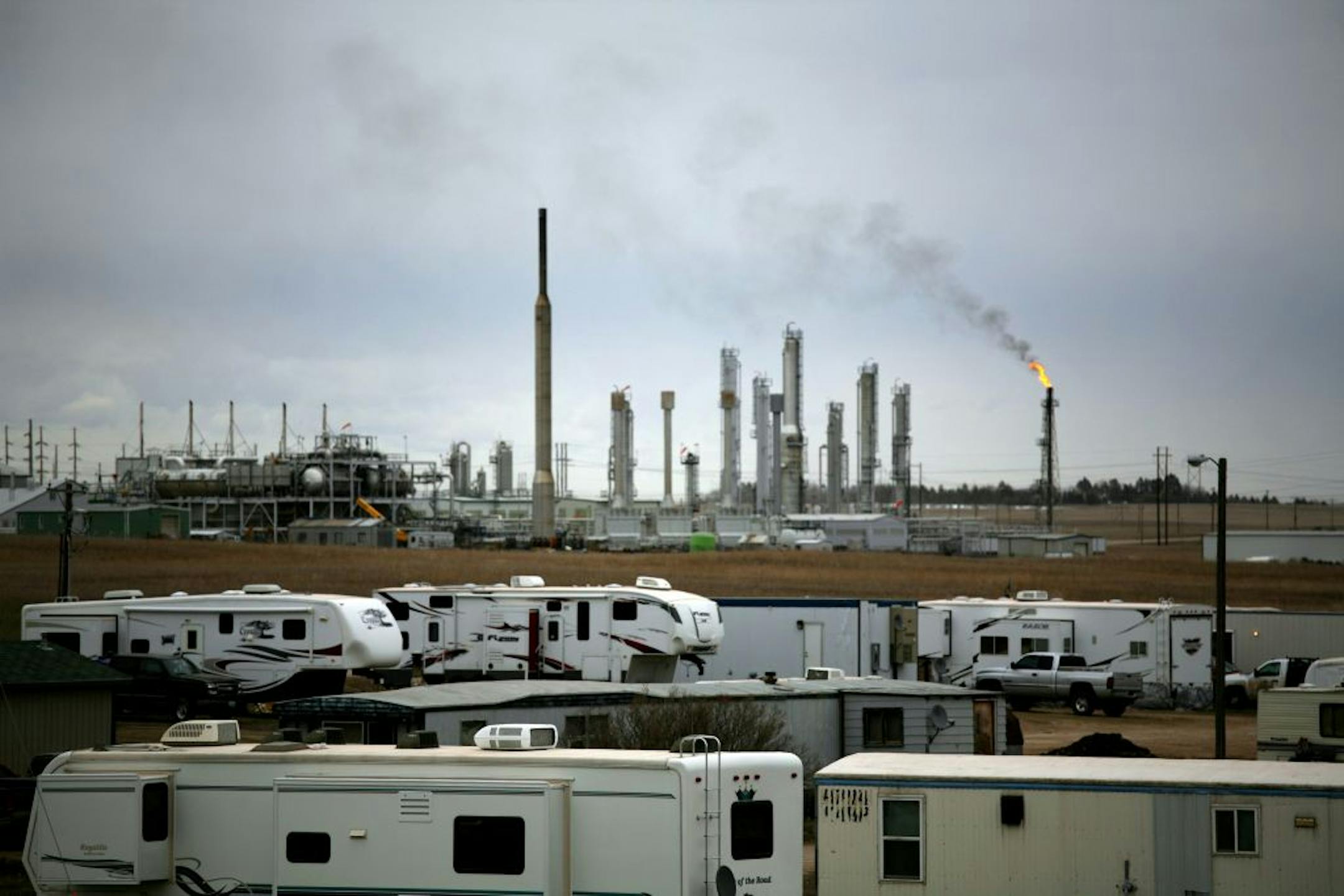 Outside an oil refinery in Williston, N.D., last year. North Dakota's oil boom and consequent need for more permanent housing has resulted in new construction sites — and more sales for Satellite.