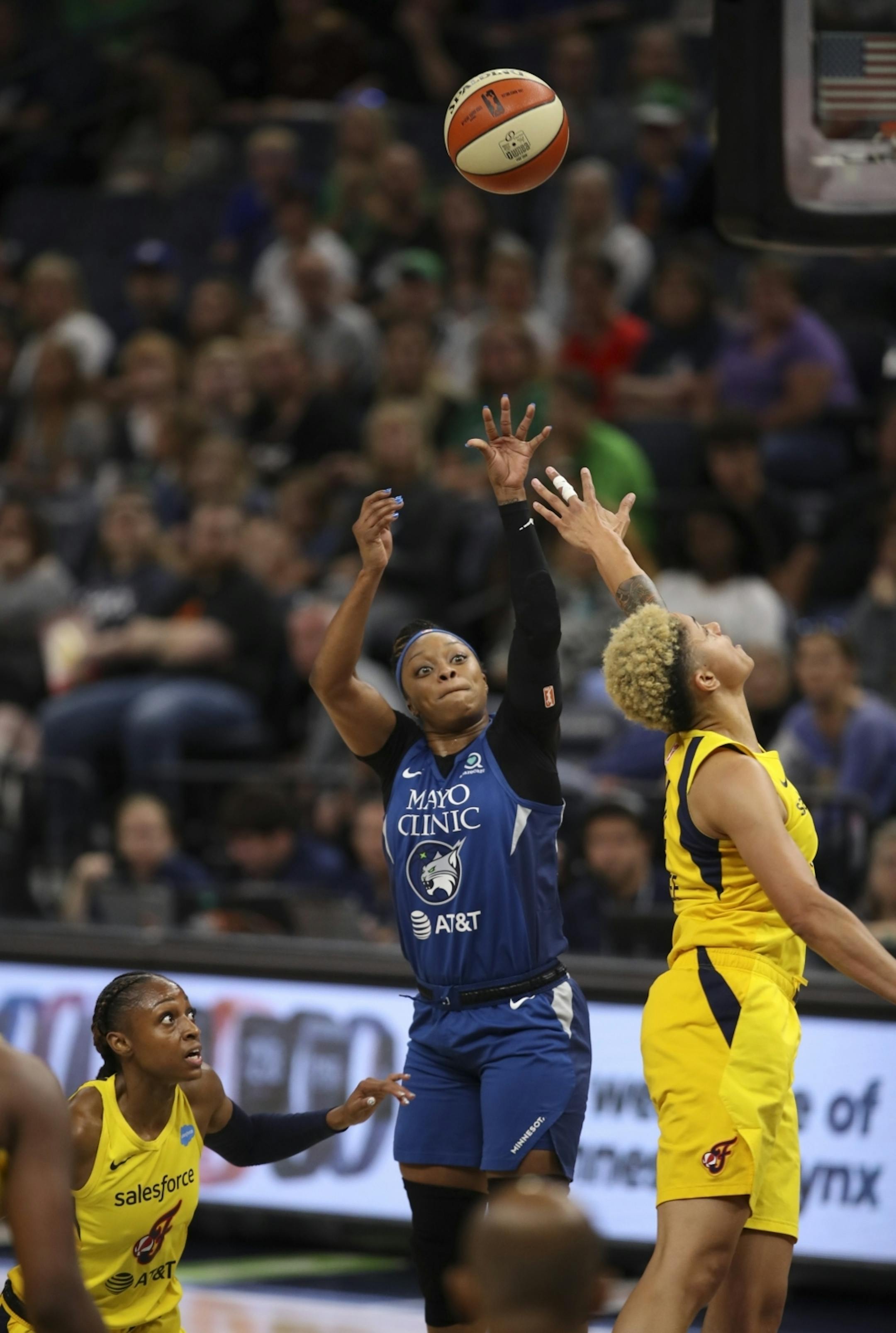 Minnesota Lynx guard Odyssey Sims (1) shot over the defense of Indiana Fever forward Candice Dupree. Fever guard Tiffany Mitchell was at left. Sims led the Lyns with 17 points.