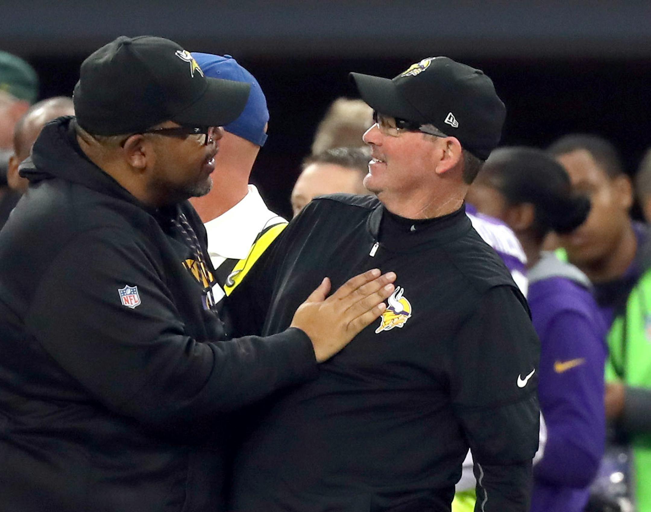 Minnesota Vikings head coach Mike Zimmer was congratulated on winning the game and the NFC North title by defensive line coach Andre Patterson as the clock wound down.