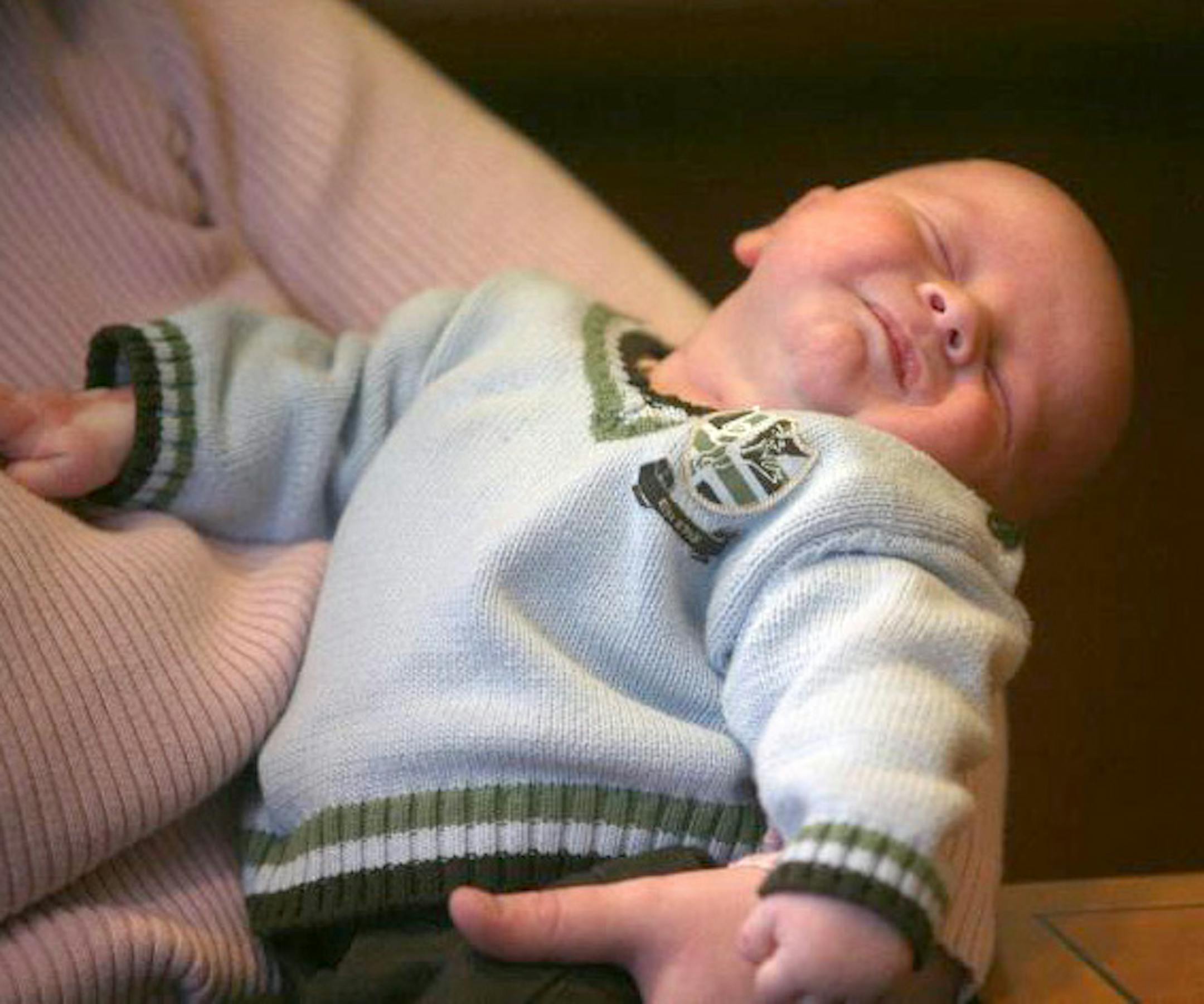 Baby Maverick, six weks old, slept in his mother's arms during the parents' first interview with news media.