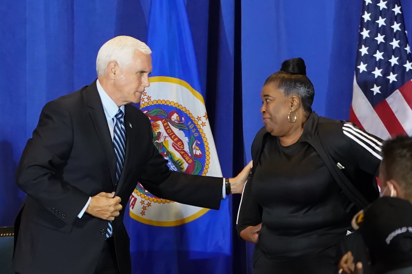 Vice President Mike Pence with Flora Westbrooks, who lost the Minneapolis hair salon she owned since 1986 to rioters, at a "Cops for Trump" campaign event at the Intercontinental Hotel.