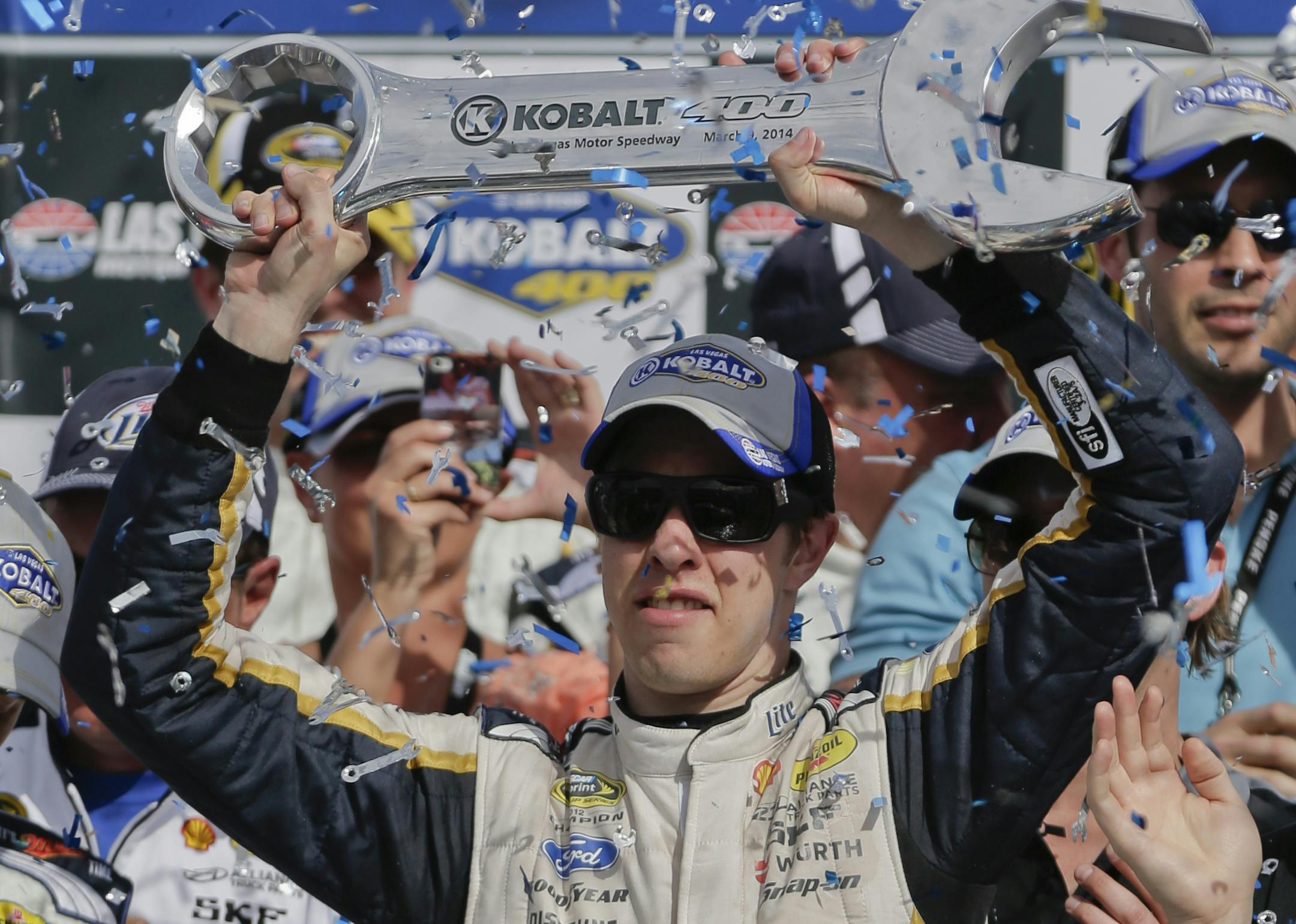 Brad Keselowski holds up the Kobalt 400 trophy after winning Sunday's NASCAR Sprint Cup Series race on Sunday, March 9, 2014, in Las Vegas.