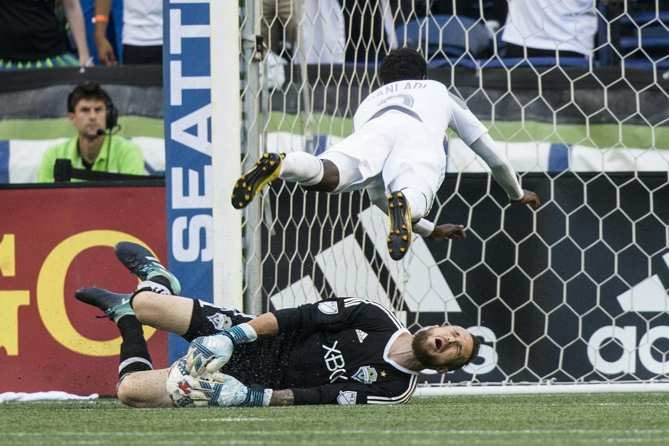 Minnesota United forward Abu Danladi fouls Seattle Sounders goalkeeper Stefan Frei and gets a yellow card during the first half of an MLS soccer match Sunday, Aug. 20, 2017, in Seattle. (Bettina Hansen/The Seattle Times via AP)