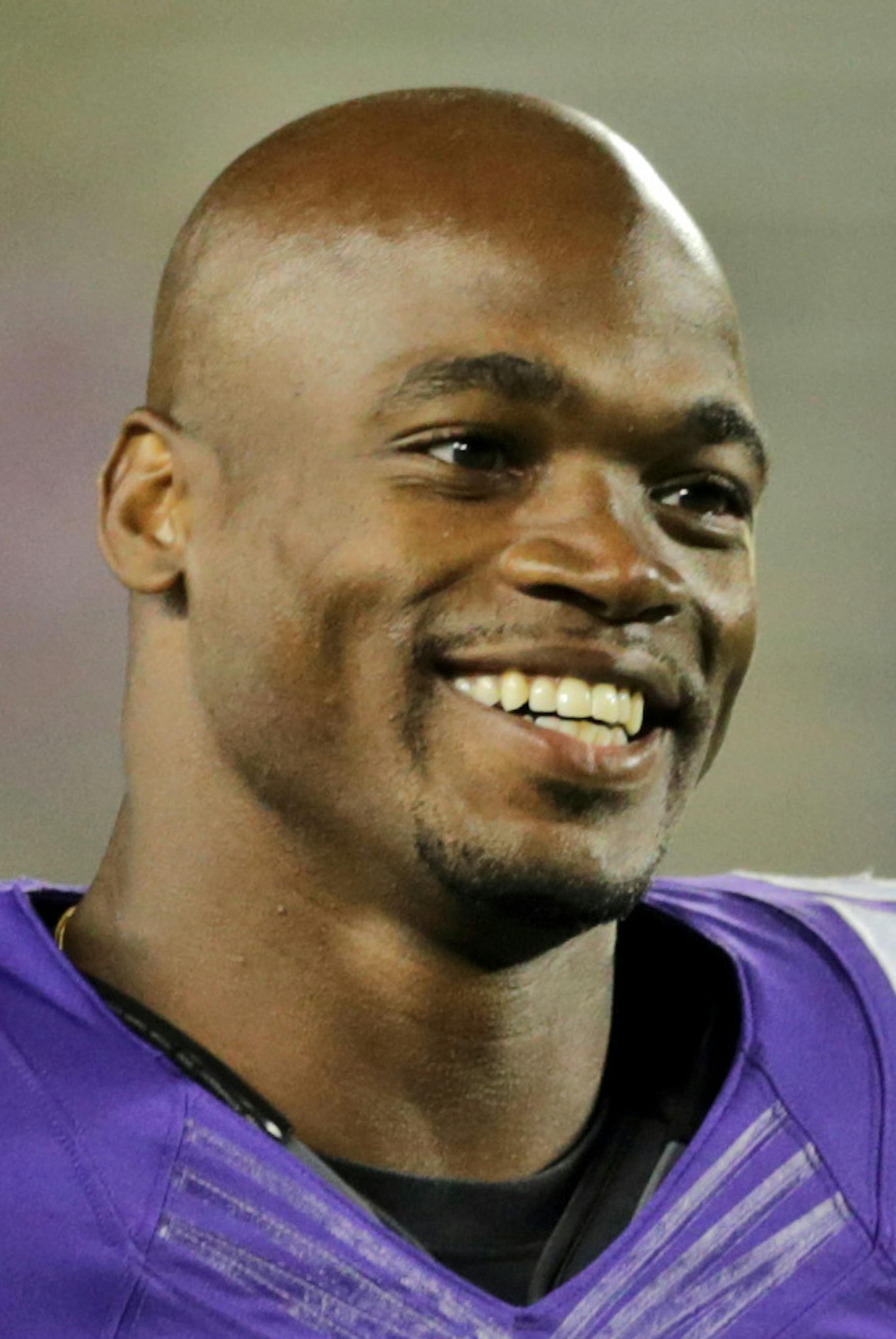 FILE - In this Aug. 8, 2014, file photo, Minnesota Vikings running back Adrian Peterson leaves the field after an NFL preseason football game against the Oakland Raiders in Minneapolis. The NFL has reinstated Minnesota Vikings running back Adrian Peterson, clearing the way for him to return after missing most of last season while facing child abuse charges in Texas. The league announced its decision on Thursday, April 16, 2015. (AP Photo/Jim Mone, File)