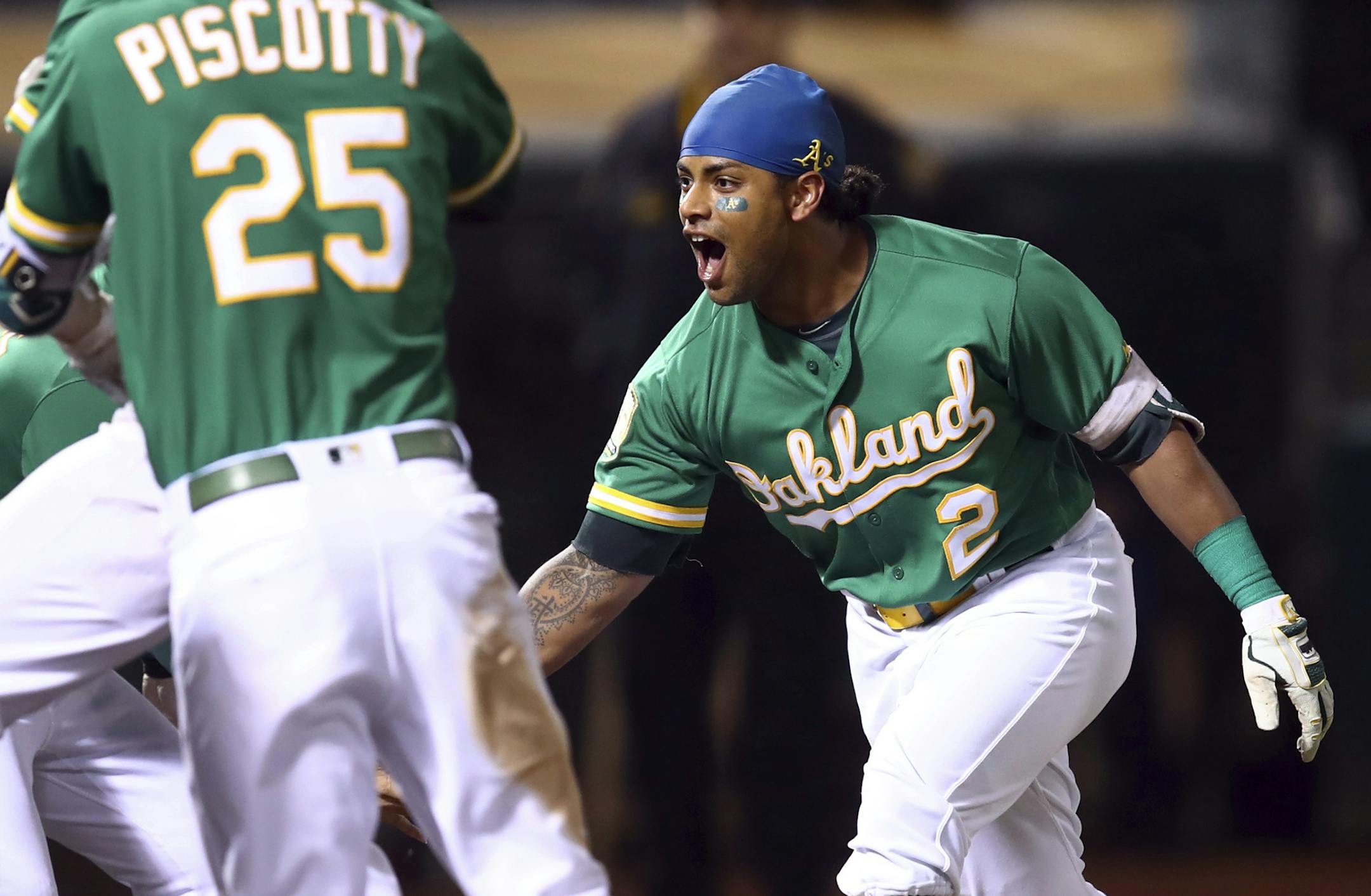 Oakland Athletics' Khris Davis, right, celebrates after hitting a walk-off home run in the 10th inning of the team's baseball game against the Minnesota Twins on Friday, Sept. 21, 2018, in Oakland, Calif. (AP Photo/Ben Margot)