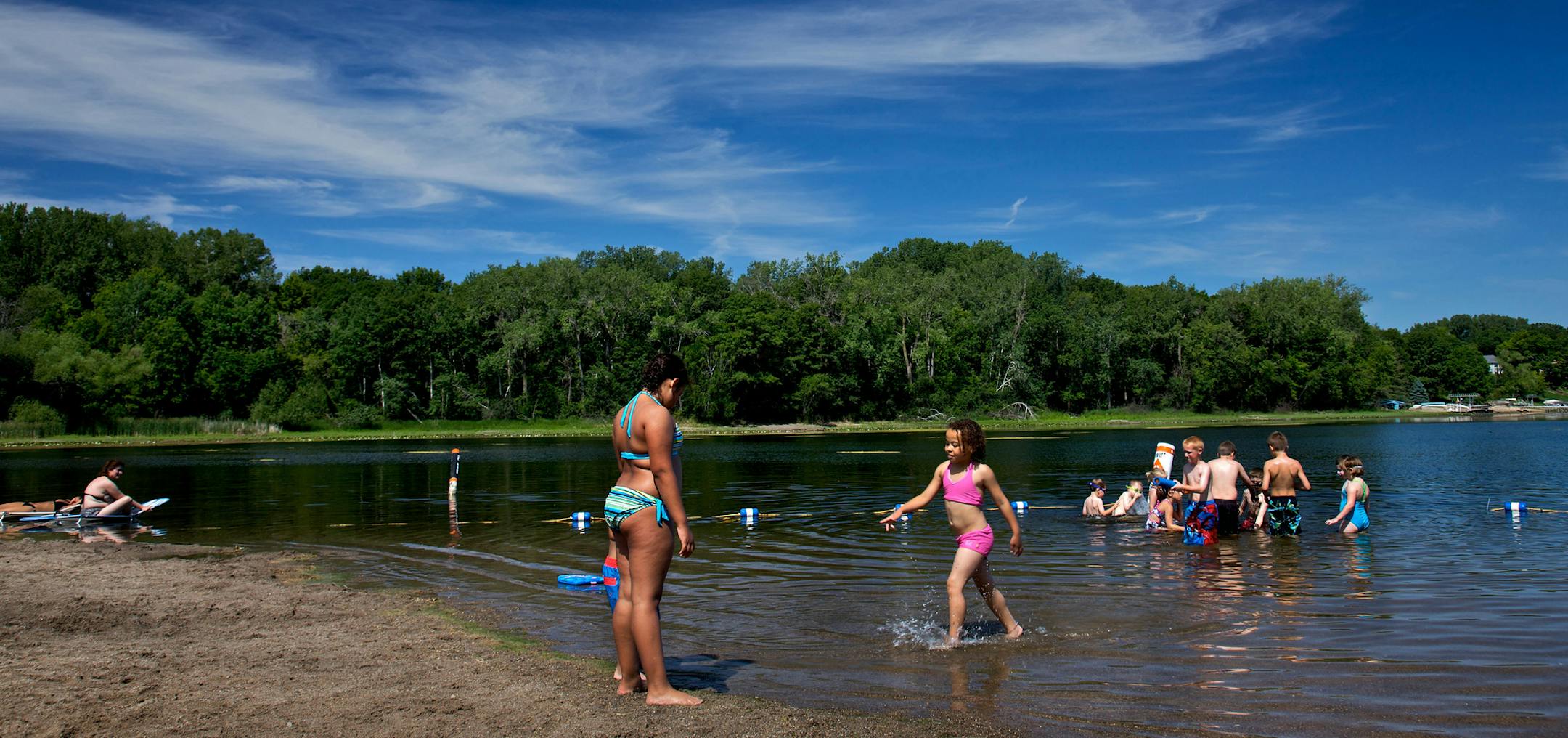STEVE RICE &#xc7;&#x192;&#xa2; srice@startribune.com Shoreview, MN 06/26/2009] On a hot almost 90-degree day, local residents of Shoreview enjoy the beach and water at Snail Lake.
