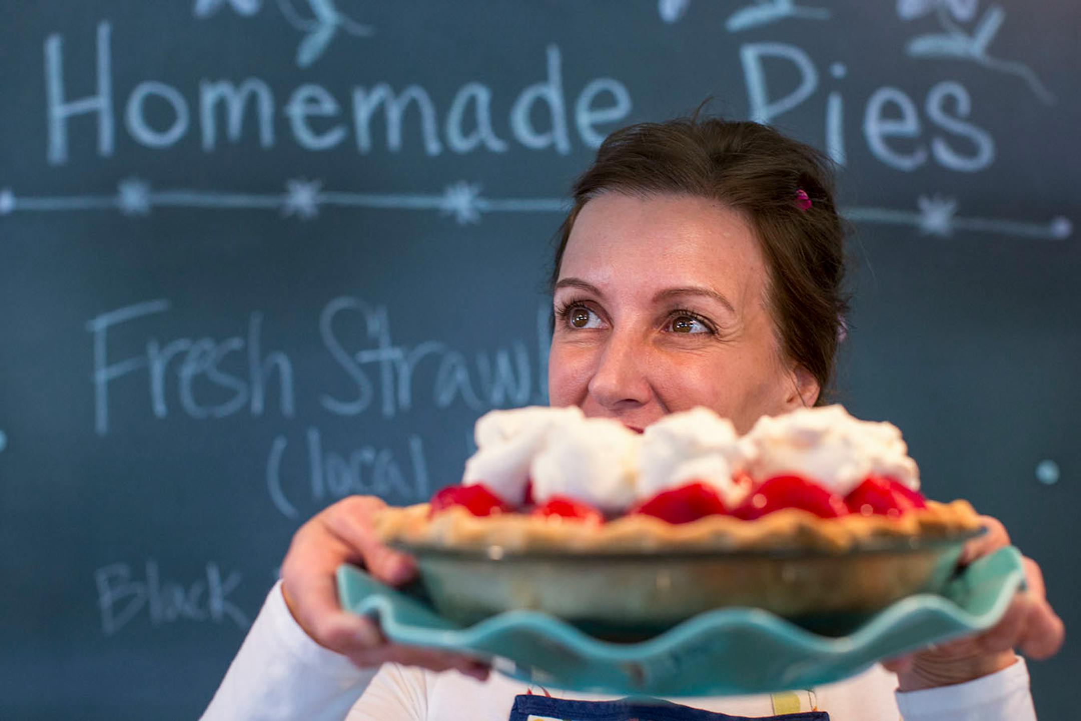Homemade Cafe owner, Julie Elwell, poses for a portrait while holding a fresh homemade strawberry pie in front of her. ] COURTNEY PEDROZA • courtney.pedroza@startribune.com June 22-24, 2017; Wisconsin restaurants, cafes, bars, bakeries and breweries; Dining along the Mississippi River.