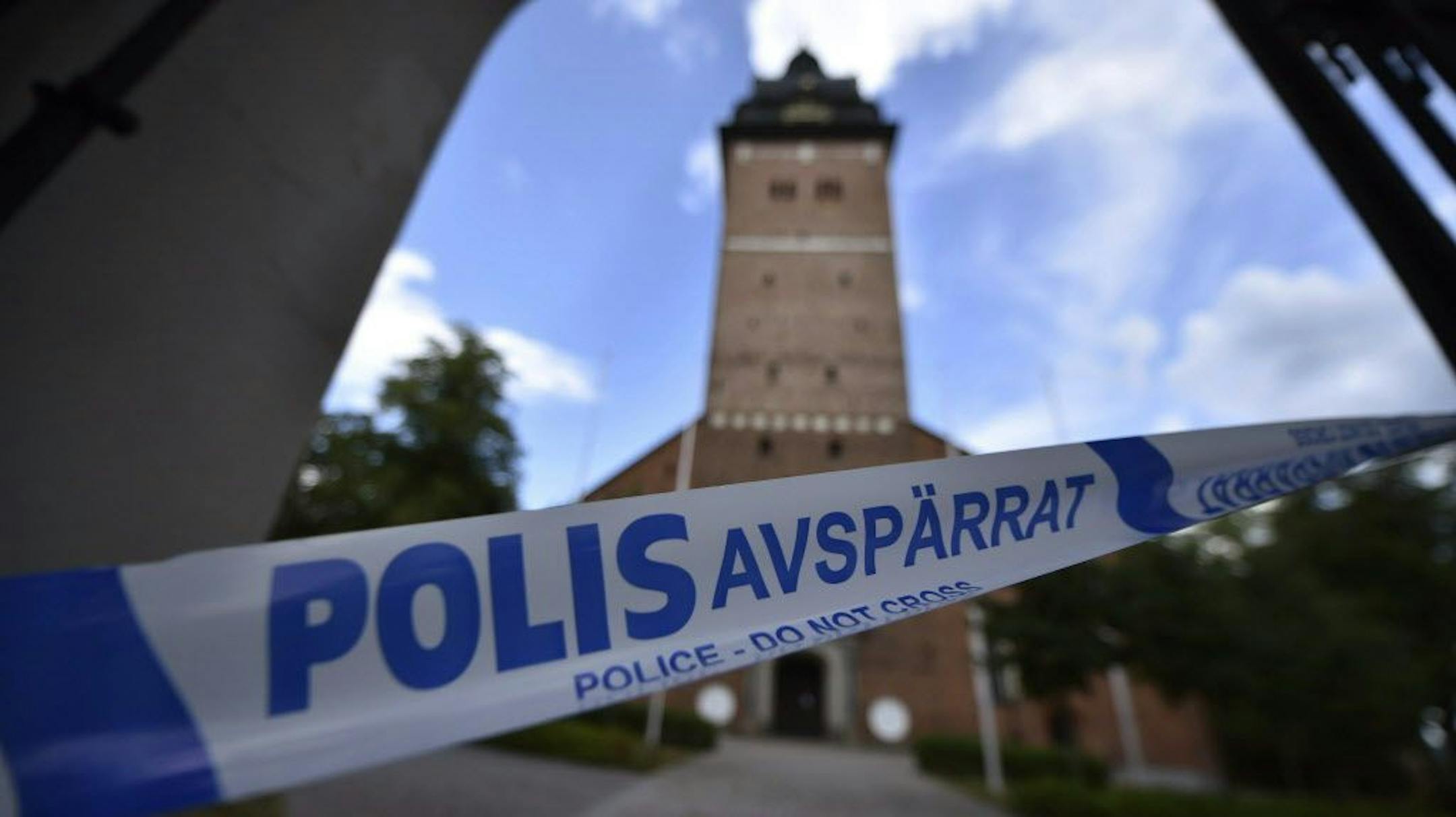 In this Tuesday, July 31, 2018 photo, a police cordon near the scene of a robbery at the Strangnas Cathedral, in Strangnas, Sweden. Police say thieves have stolen priceless treasures from the Swedish royal regalia, including a jeweled crown, from a cathedral where they were on display, before speeding off by motorboat.