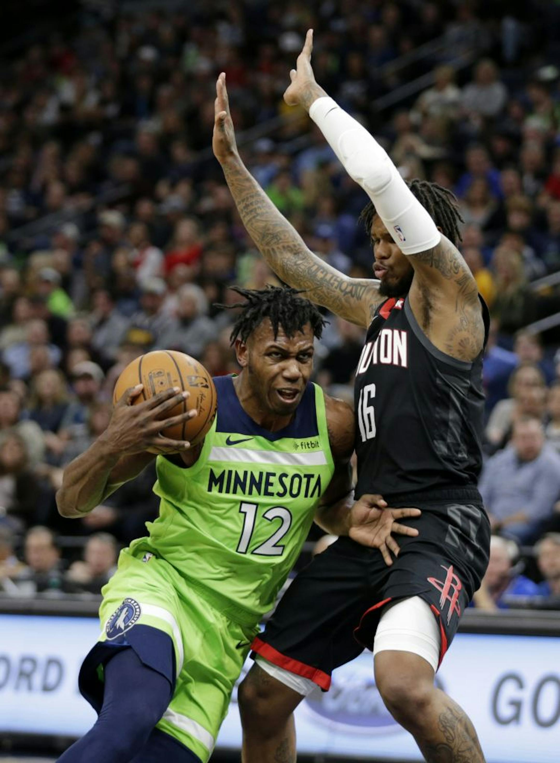 Minnesota Timberwolves guard Trevion Graham (12) drives on Houston Rockets guard Ben McLemore (16) in the first quarter during an NBA basketball game Saturday, Nov. 16, 2019 in Minneapolis.