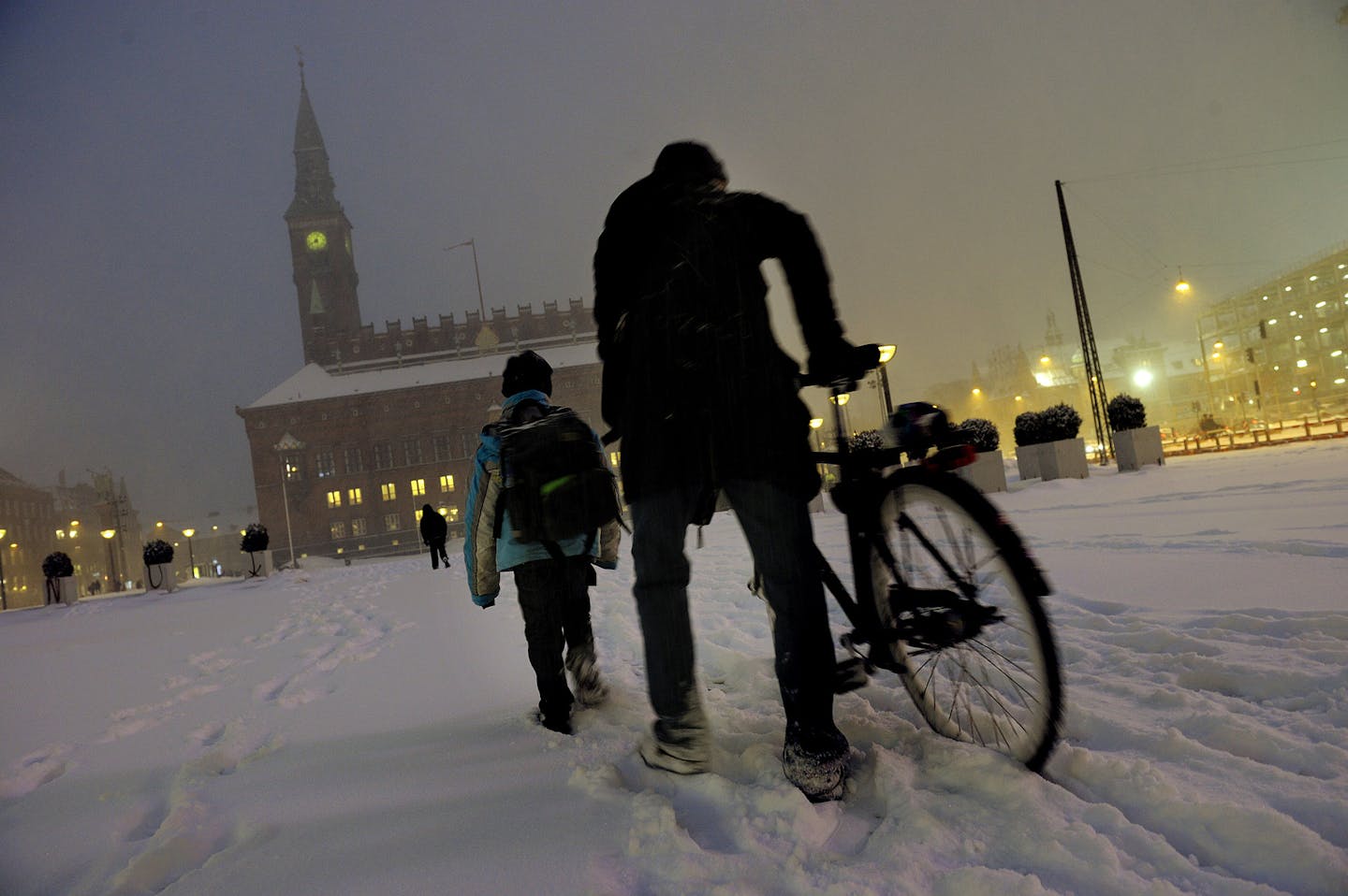 A man and his boy crossed Raadhuspladsen, the Town Hall Square, as it was hit by a blizzard early Thursday morning in Copenhagen, Denmark,Thursday, Jan. 6, 2011. (AP Photo/Kristian Linnemann/ POLFOTO) DENMARK OUT