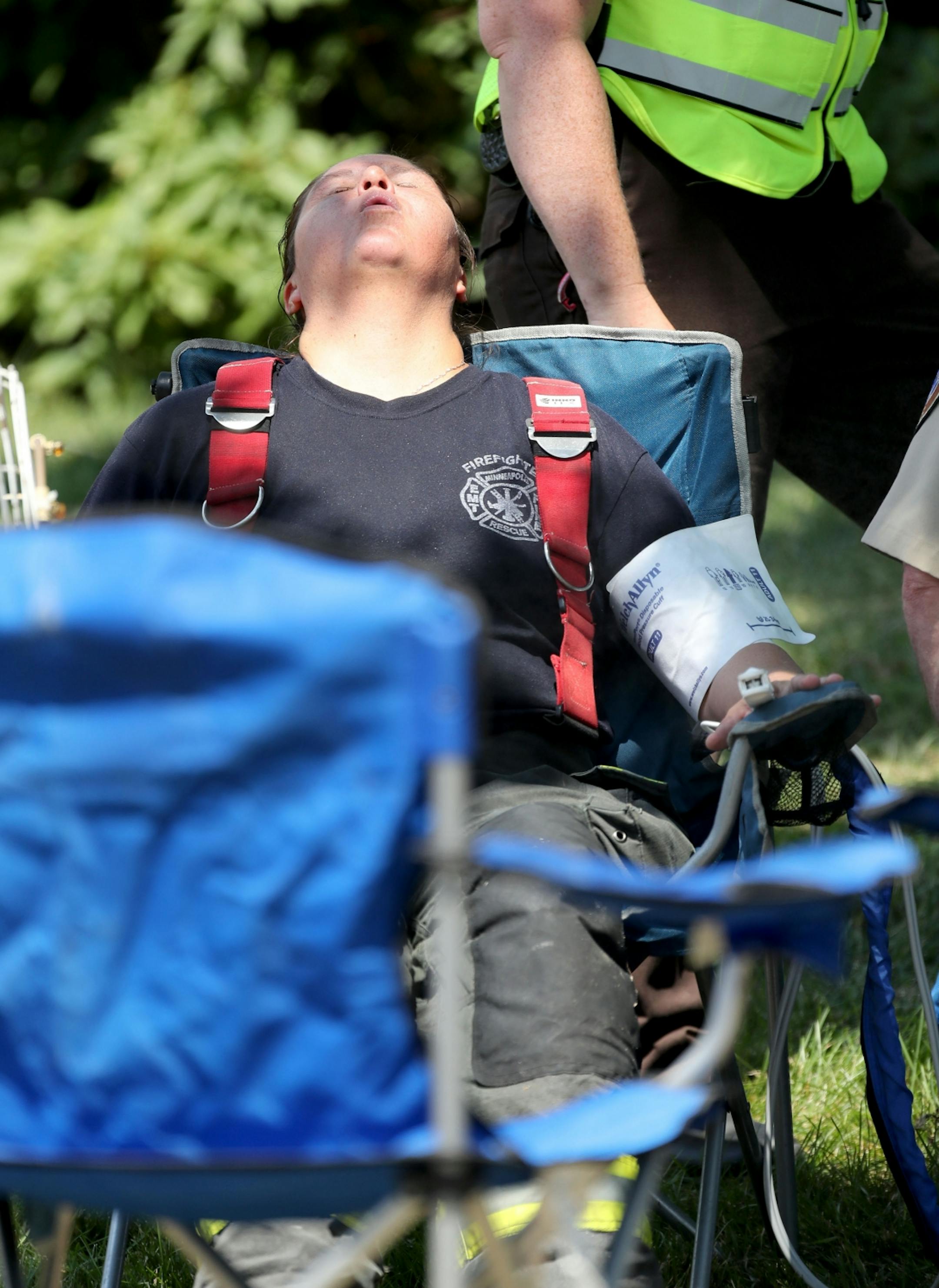 At least one person is dead following an explosion and building collapse at Minnehaha Academy. Here, a hot, exhausted firefighter gets medical attention near the explosion site Wednesday, Aug. 2, 2017, in Minneapolis, MN.