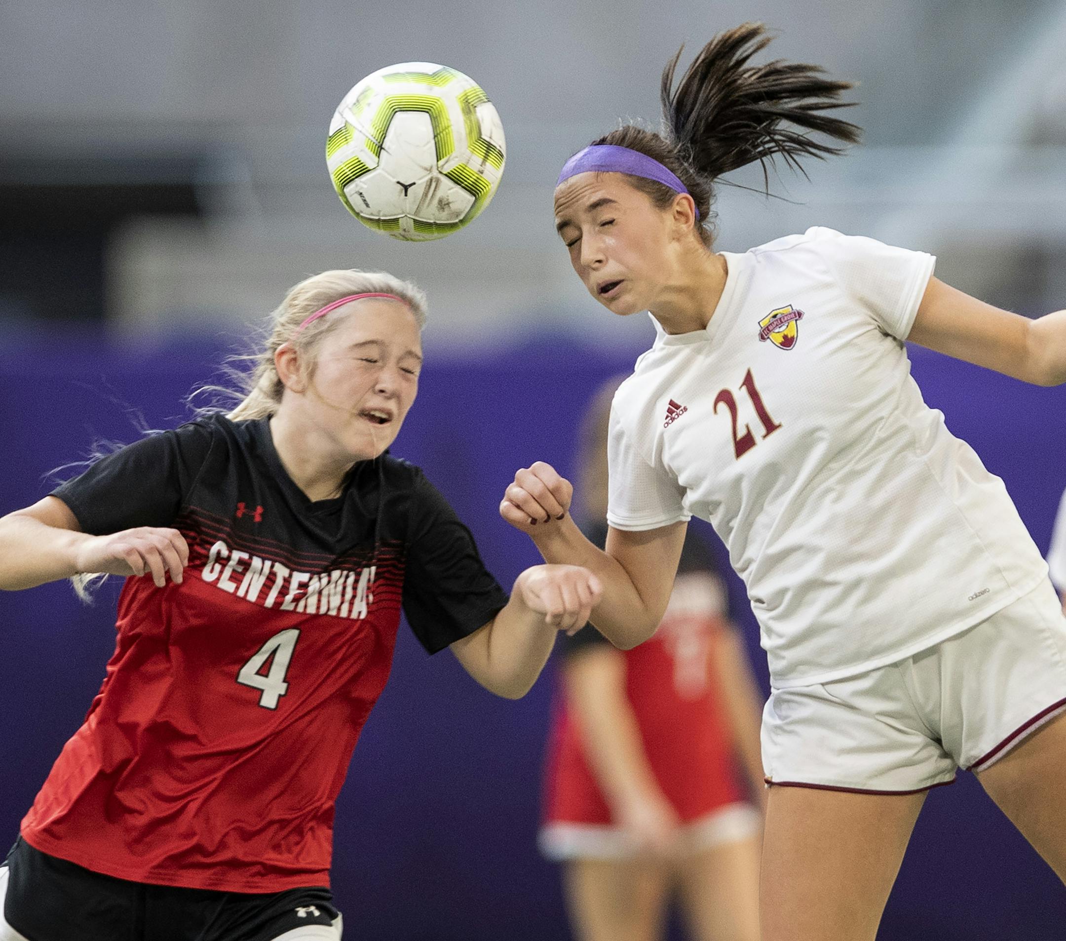 Brittany Bordson (4) of Centennial and Kelley Kloncz (21) of Maple Grove fought for a ball in the first half. ] CARLOS GONZALEZ • cgonzalez@startribune.com – Minneapolis, MN – October 31, 2019, U.S. Bank Stadium, High School / Prep Soccer Finals, Girls' 2A game, Maple Grove vs. Centennial