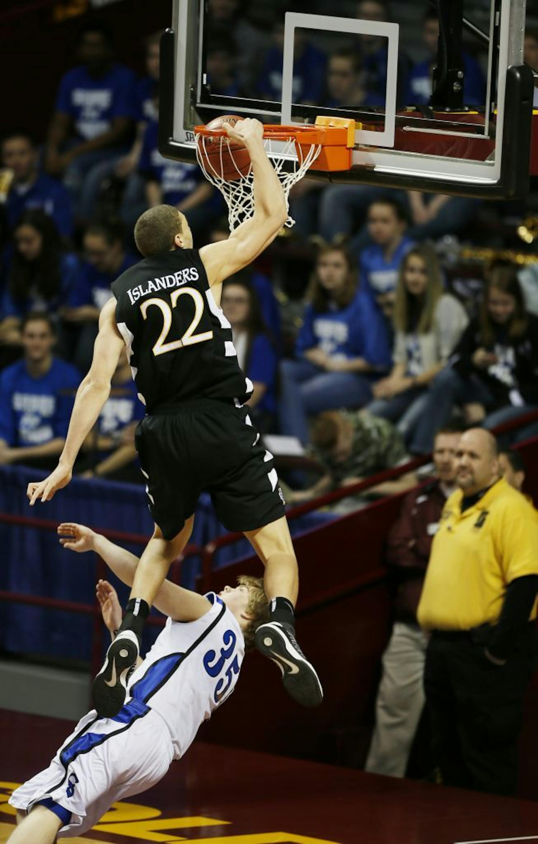 Reid Travis of DeLaSalle dunked over Dylan Hollenkamp of Sartell during 3A quarterfinals basketball action between DeLaSalle and Sartell-St. Stephen at Williams Arena Wednesday March, 20, 2013 in Minneapolis, MN.