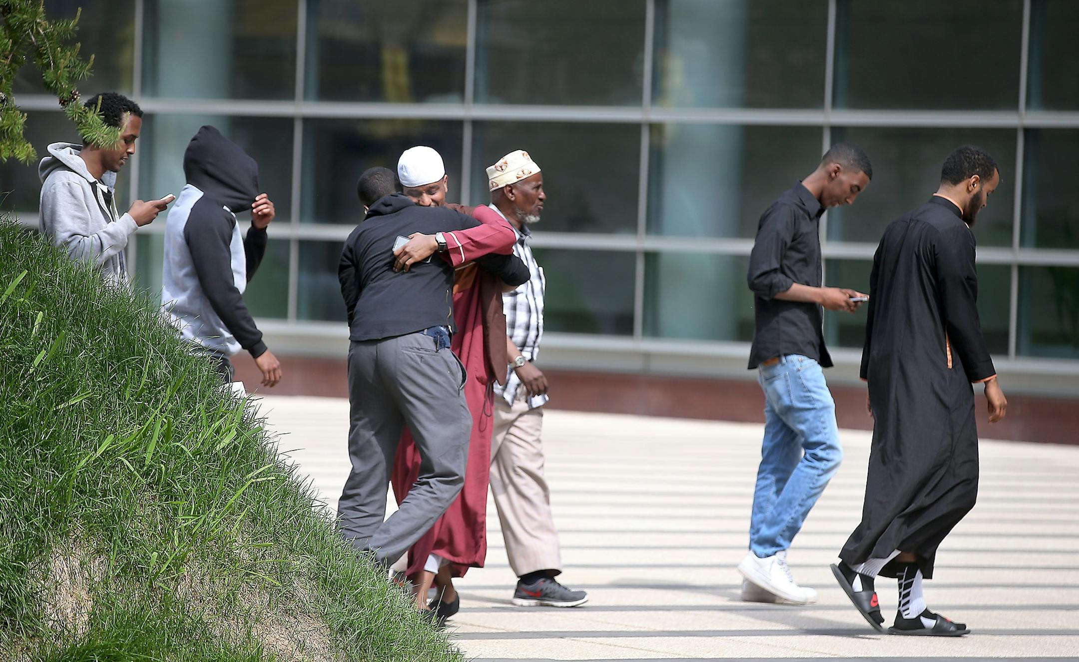 Family members of young Somali men standing trial, made their way into the opening day of the ISIL recruit trial after a break, in front of the United States Courthouse, Monday, May 9, 2016 in Minneapolis, MN.