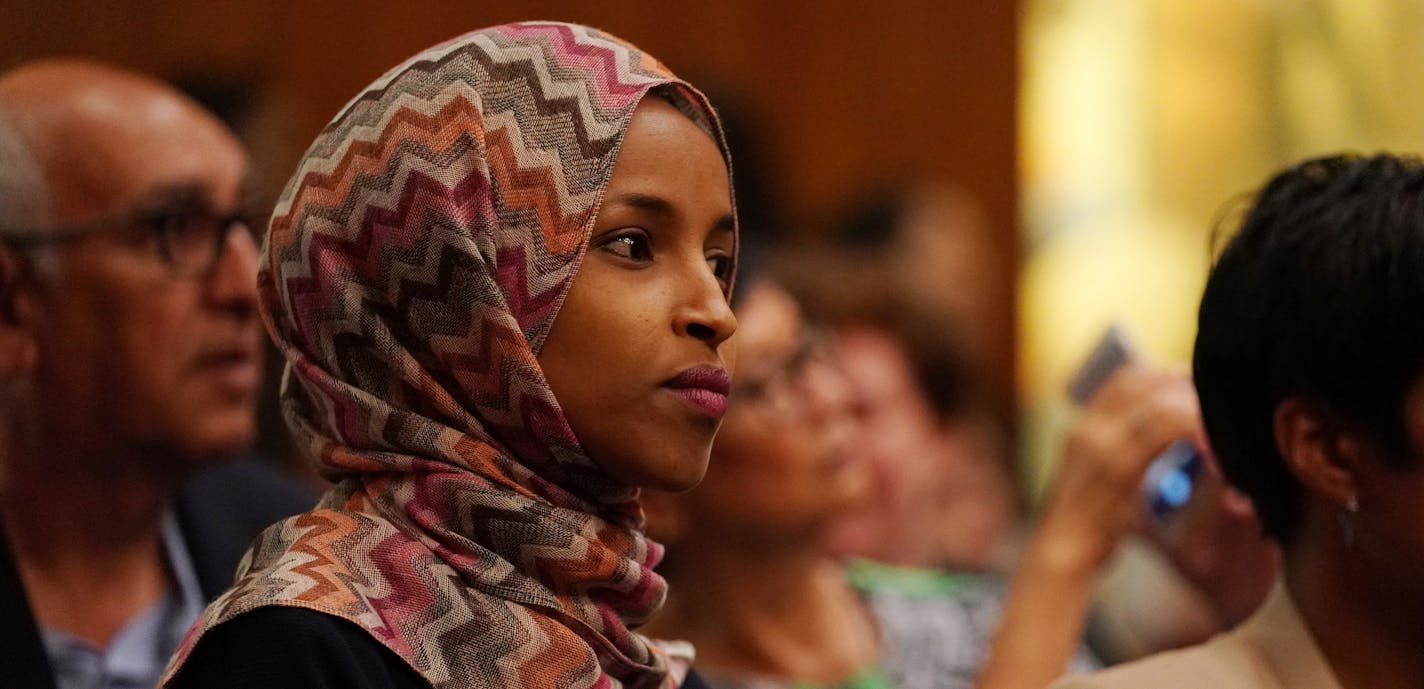 State Rep. Ilhan Omar, a DFL candidate for Congress, sat during new city council member Mitra Jalali Nelson's swearing in at St. Paul City Hall. ] ANTHONY SOUFFLE &#xef; anthony.souffle@startribune.com New St. Paul City Council member Mitra Jalali Nelson was sworn in as the new Fourth Ward City Council member Wednesday morning City Hall in St. Paul, Minn.