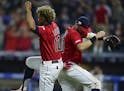 Cleveland Indians' Francisco Lindor, left, and Tyler Naquin celebrate after the Indians defeated the Detroit Tigers 7-2 in a baseball game Wednesday, 