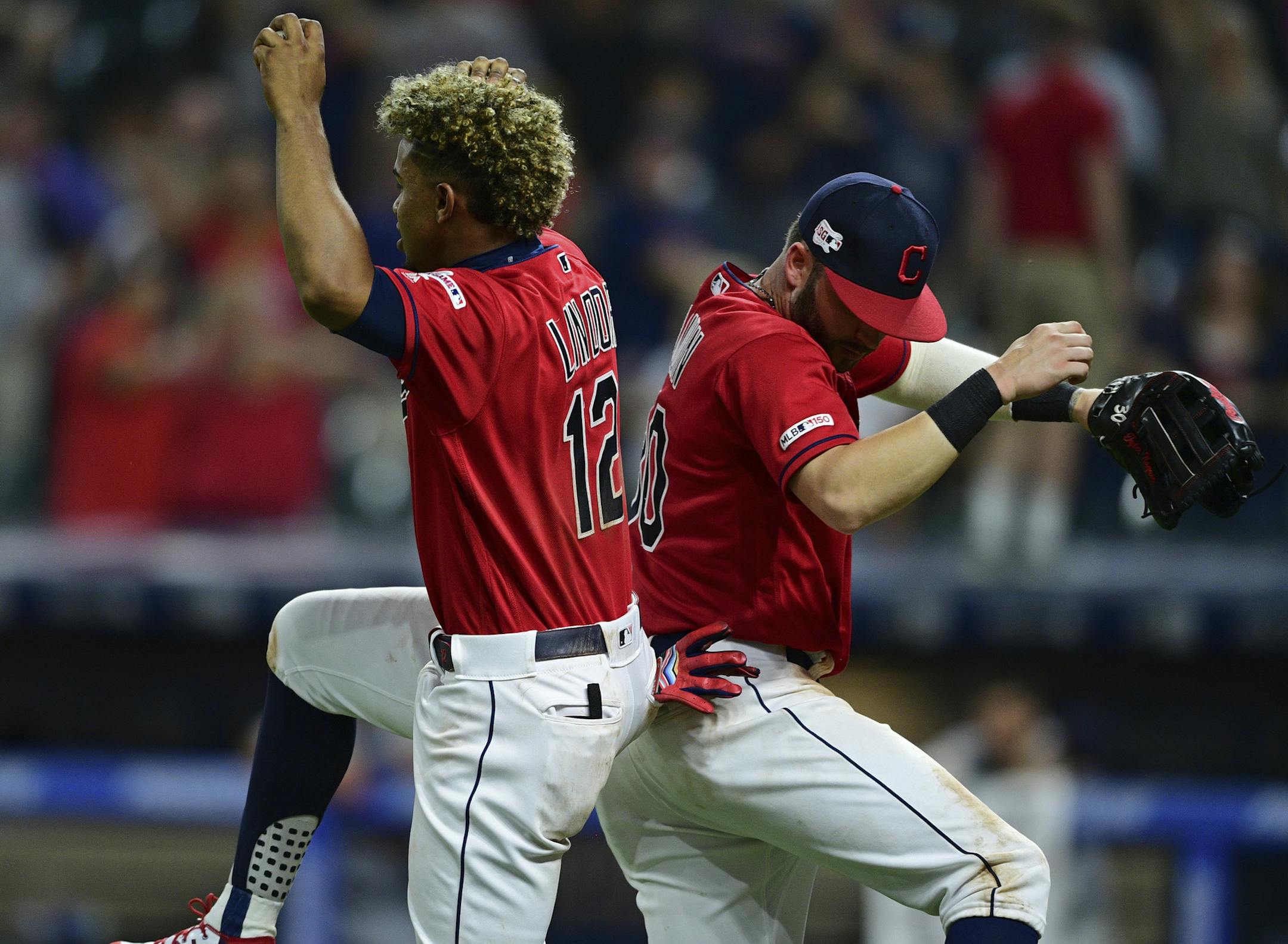Cleveland Indians' Francisco Lindor, left, and Tyler Naquin celebrate after the Indians defeated the Detroit Tigers 7-2 in a baseball game Wednesday, July 17, 2019, in Cleveland. (AP Photo/David Dermer)