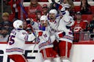 The Rangers' Chris Kreider, second from right, celebrates one of his three goals in the third period in a 5-3 victory over Carolina to clinch the East