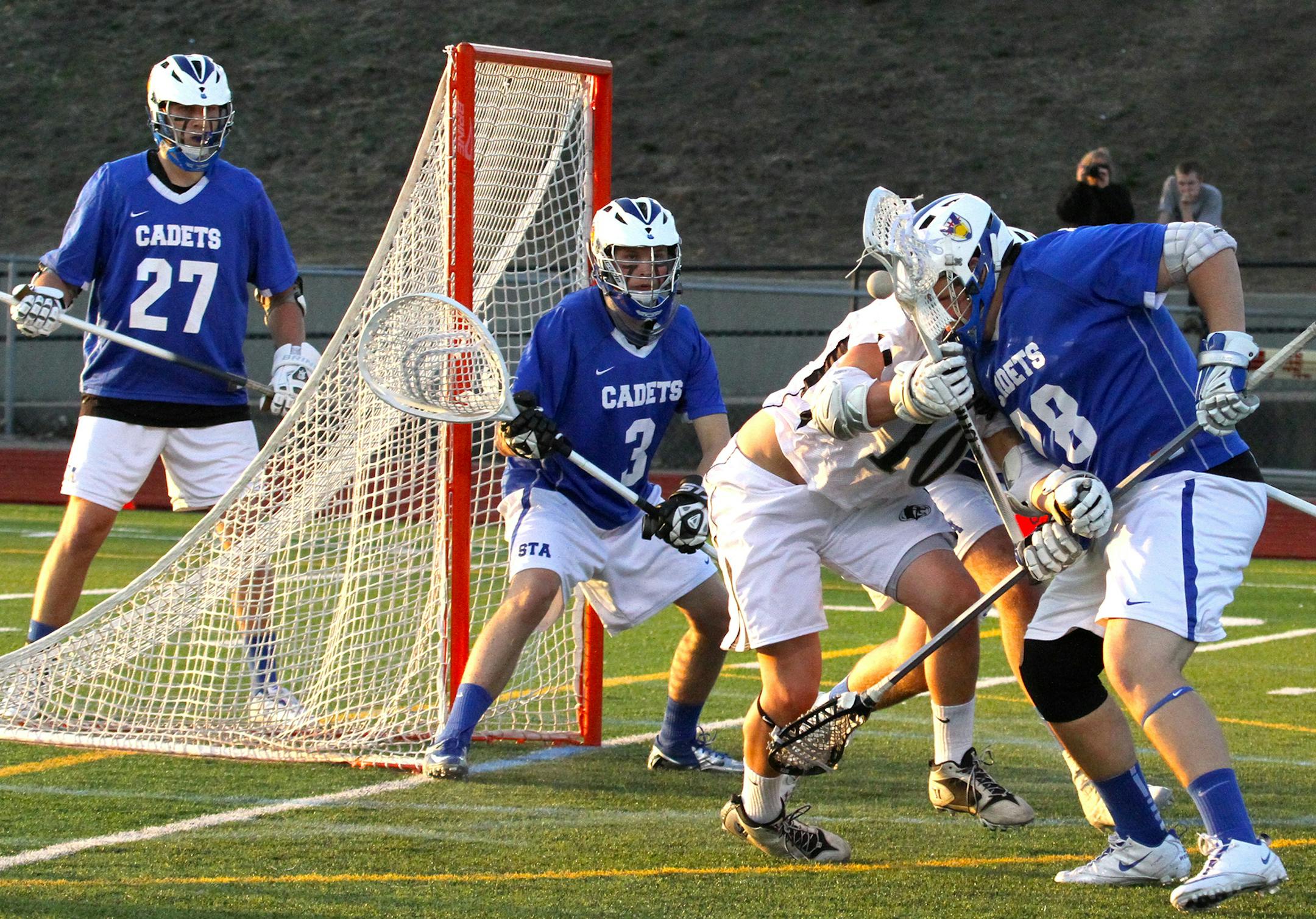 Photographer: Jennifer Weichert. Saint Thomas players are as follows: Chase Bockstruck (senior) is the goalie at #3, Joe Weichert (Senior) is #28 and J.R. Riley (junior) is #27.