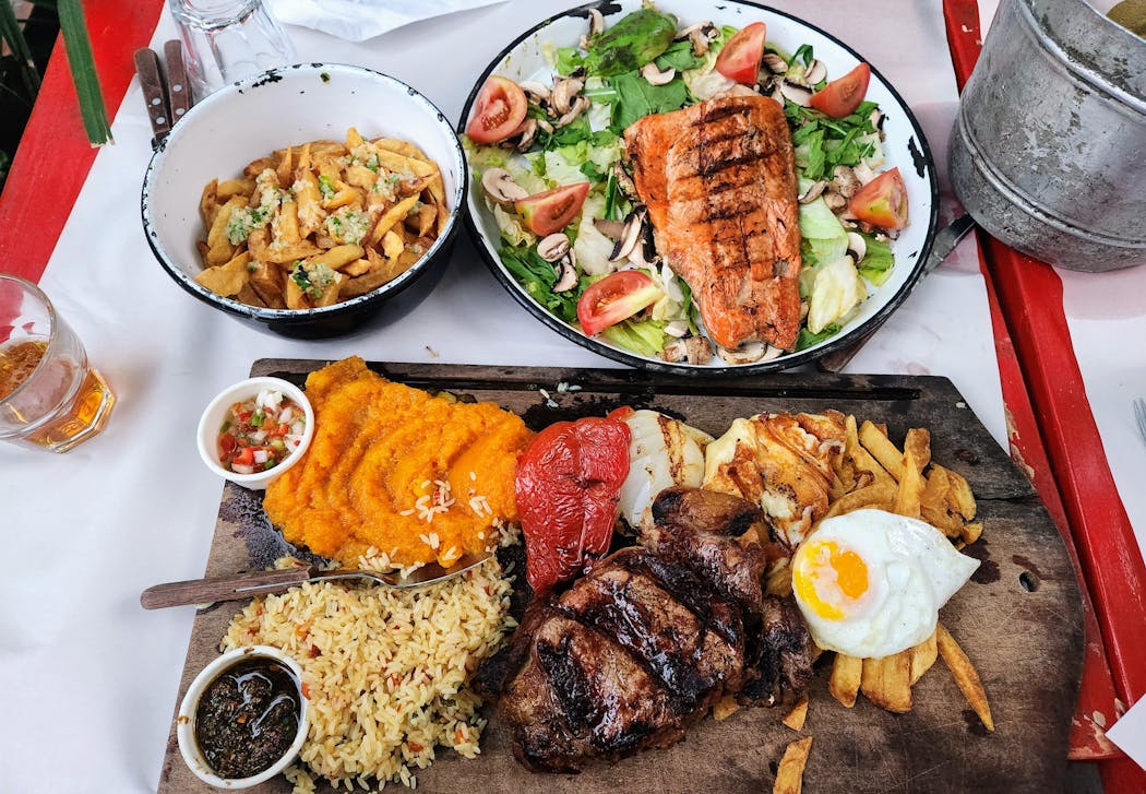 A gran bife spread at Las Cabras parilla (steakhouse) in Buenos Aires, with a salmon platter and beer and wine, cost the traveler U.S. $38.