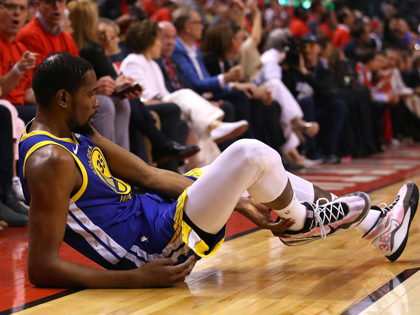 Kevin Durant (35) of the Golden State Warriors reacts after sustaining an injury during the second quarter against the Toronto Raptors during Game Five of the 2019 NBA Finals at Scotiabank Arena on Monday, June 10, 2019 in Toronto, Canada. (Gregory Shamus/Getty Images/TNS) ORG XMIT: 1334959