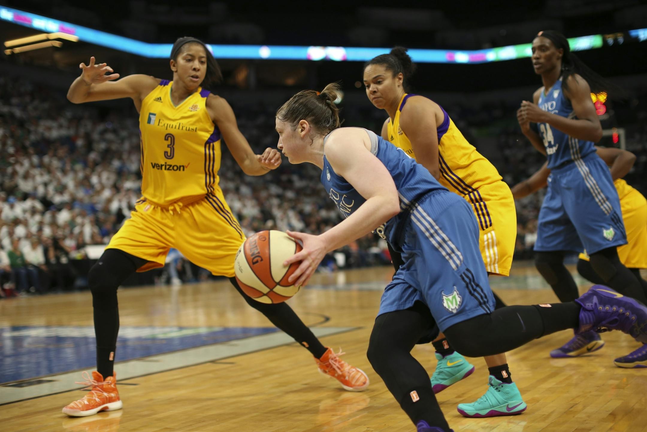 Minnesota Lynx guard Lindsay Whalen (13) drove to the net and Los Angeles Sparks forward Candace Parker (3) in the second half.