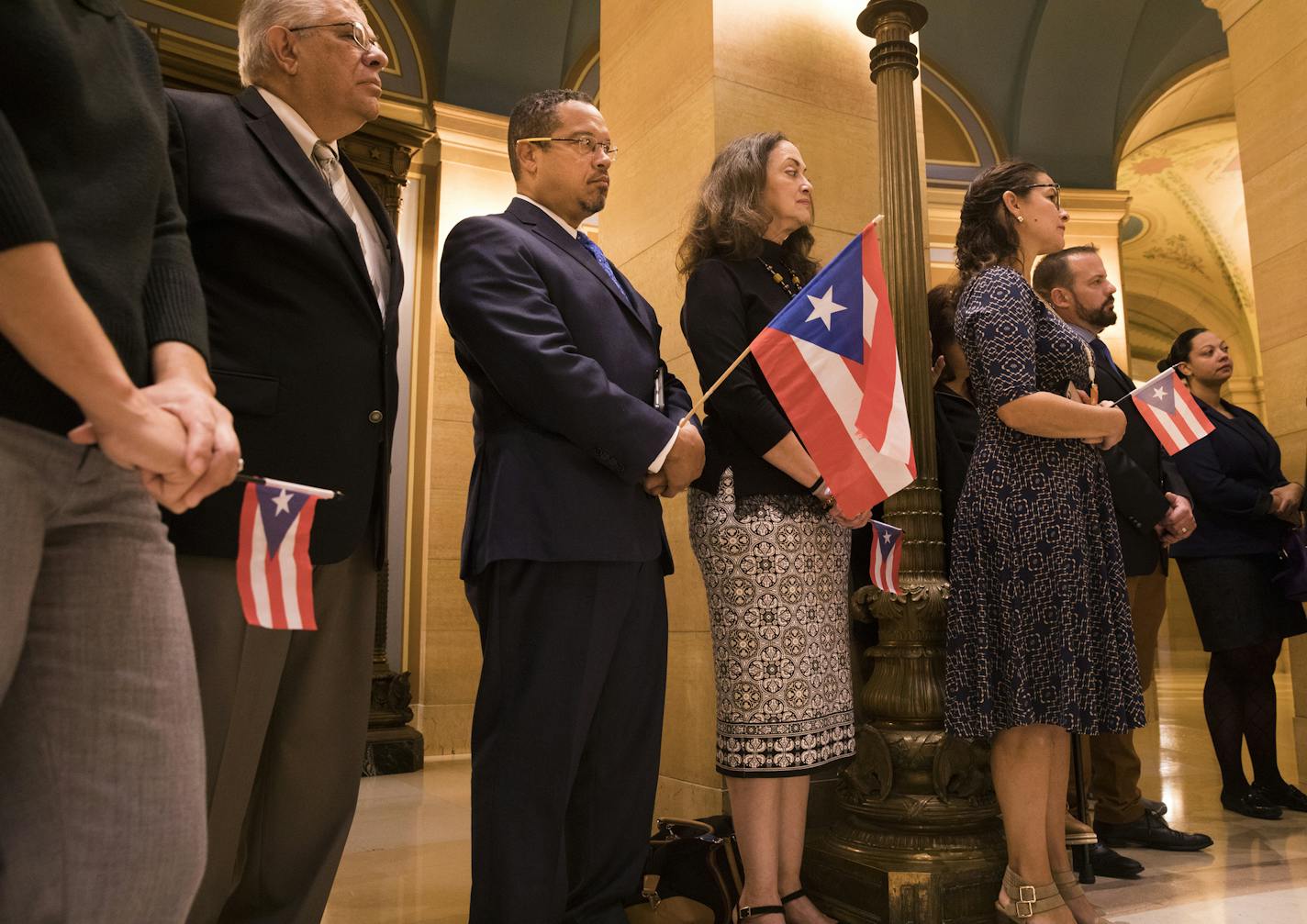 Congressman Keith Ellison holds a Puerto Rican flag with University of Minnesota physician Dr. Miguel Fiol on Ellison's left, who was in Puerto Rico during Hurricane Maria, and Aida E. Tosca on Ellison's right, a Puerto Rican living in Minnesota. ] LEILA NAVIDI &#xef; leila.navidi@startribune.com BACKGROUND INFORMATION: A group of Minnesota political leaders and representatives of advocacy groups hold a State Capitol news conference on Monday, October 2, 2017 to demand a stronger U.S. response t