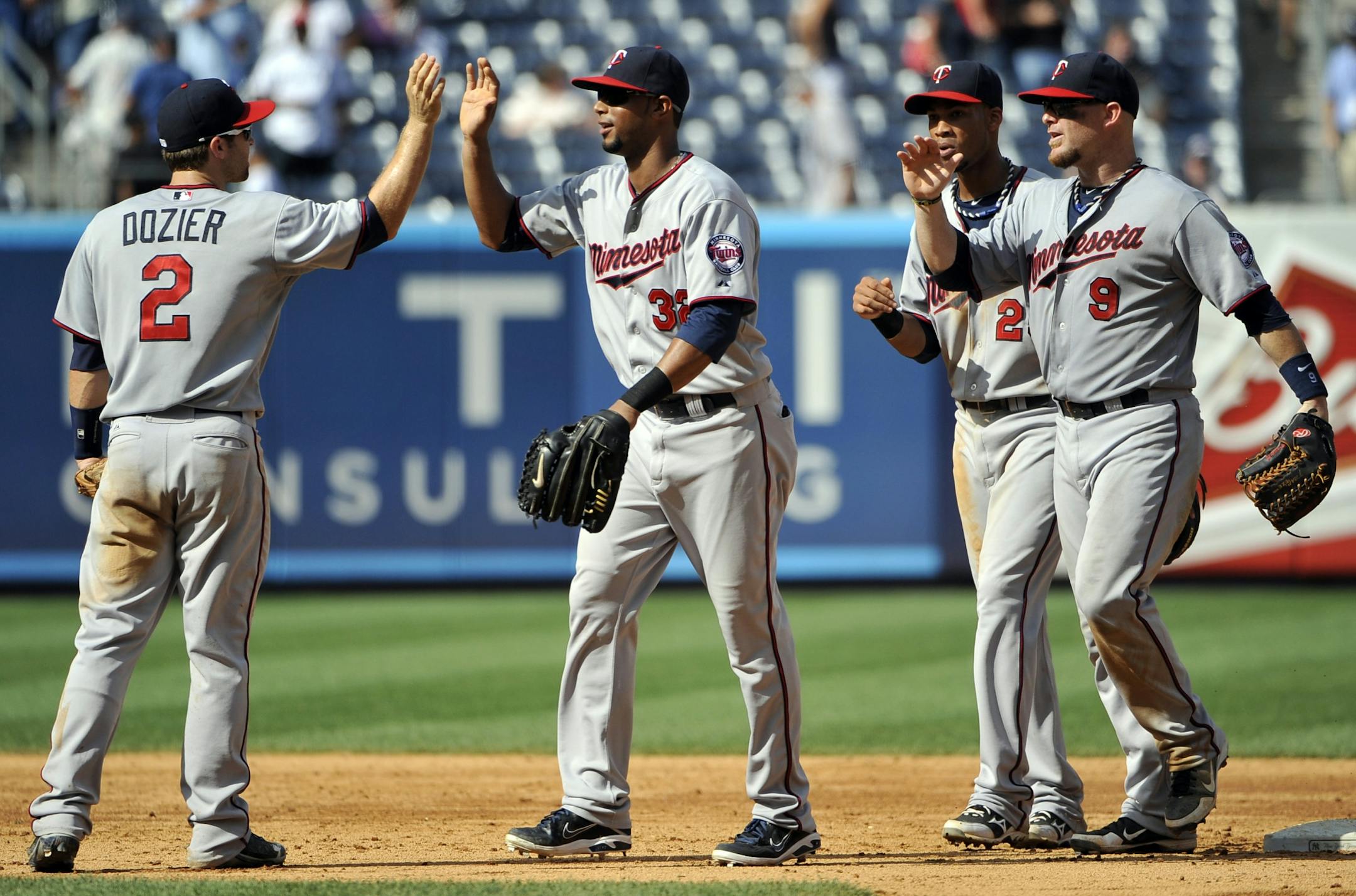 Minnesota's Brian Dozier (2), Aaron Hicks (32), Pedro Florimon (25) and Ryan Doumit (9) celebrate a 10-4 win over the New York Yankees.