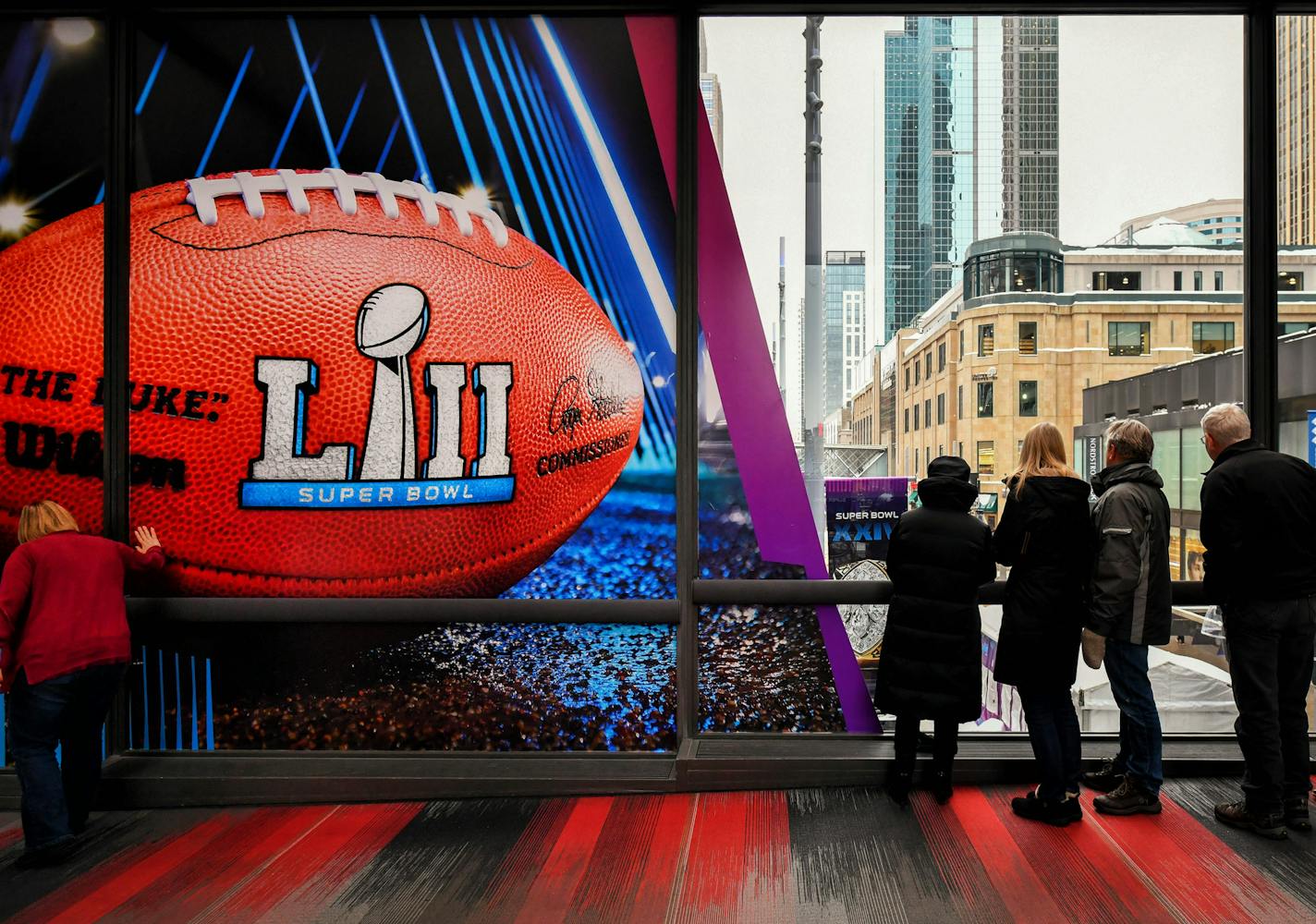 A skywalker walker couldn't resist touching the Superbowl football banner over Nicollet Mall. ] GLEN STUBBE &#x2022; glen.stubbe@startribune.com Wednesday, January 24, 2018 Photo update of the scene on Nicollet Mall as they finish up work on getting it ready for Super Bowl Live, which officially kicks off Friday afternoon.