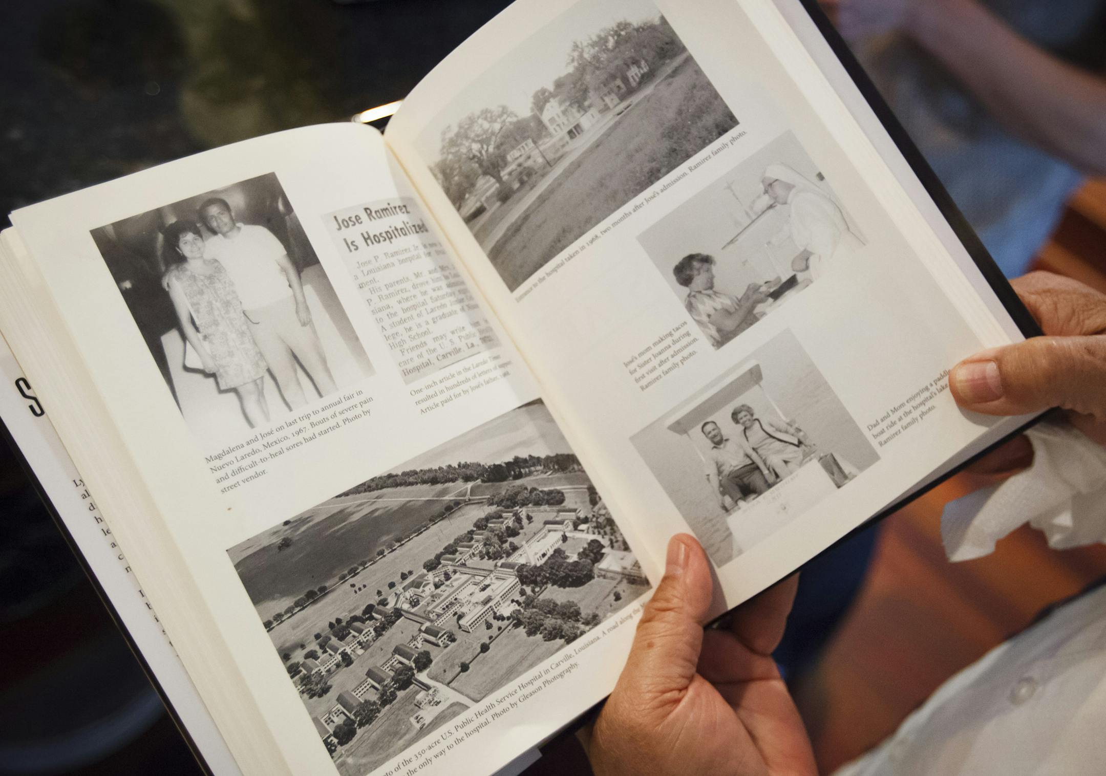 Jose Ramirez looks at pictures from his memoir about being diagnosed with leprosy at age 20, at his home in Houston, June 10, 2014. Ramierz now gives talks around the world to help eradicate a profound public ignorance about the condition which he says contributes to many survivors' shame and guilt. (Michael Stravato/The New York Times)