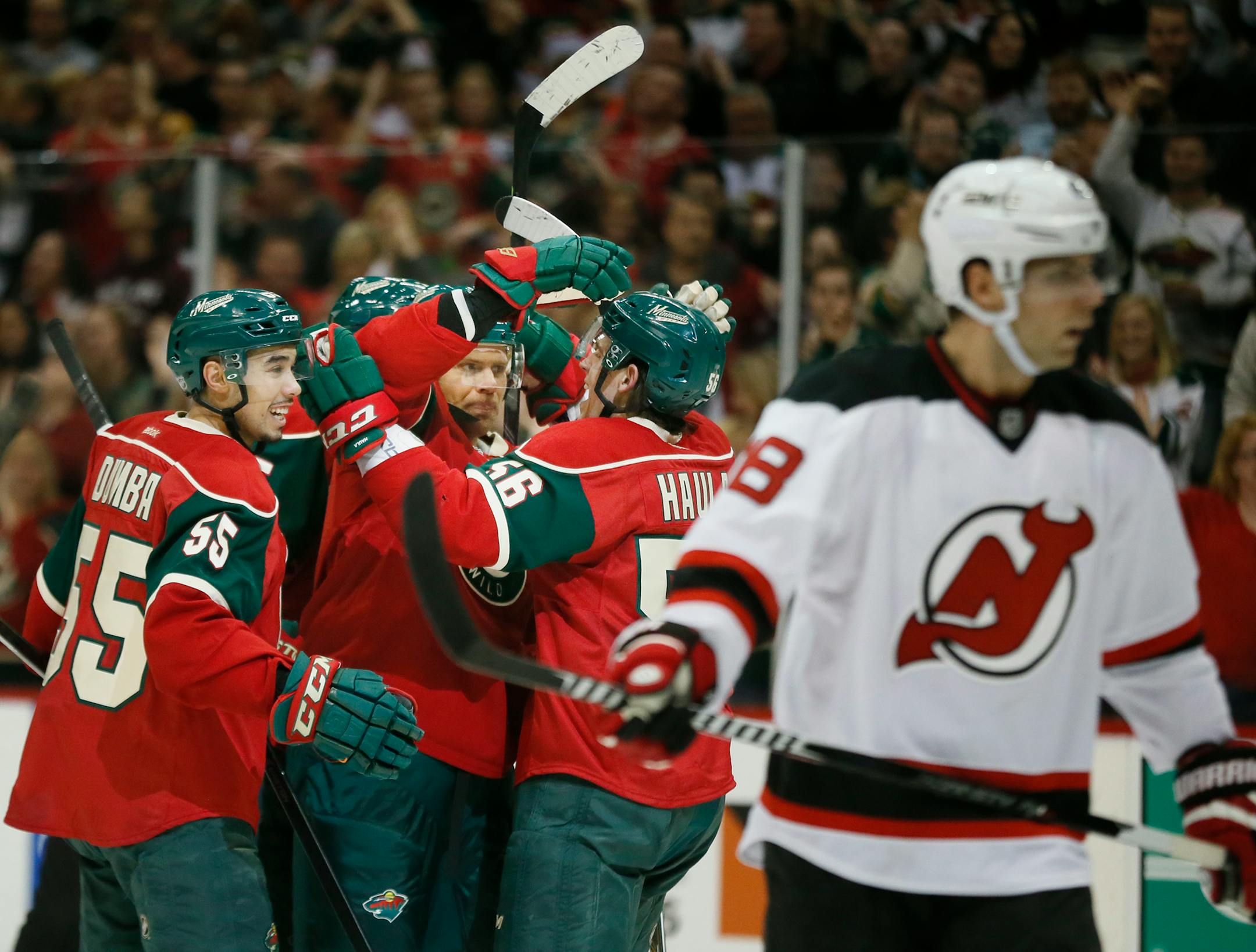 Minnesota Wild left wing Sean Bergenheim (23), center, celebrated his first period goal with Matt Dumba (55) and Erik Haula (56).