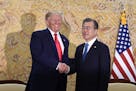 President Donald Trump and South Korean President Moon Jae-in shakes hands at the start of a bilateral meeting at the Blue House in Seoul, Sunday, Jun