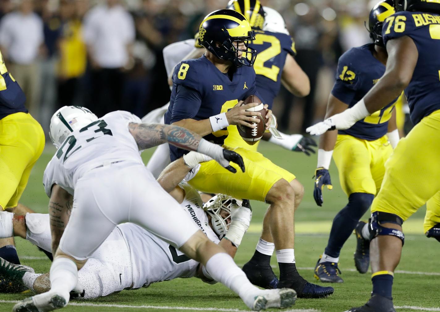 Michigan quarterback John O'Korn is sacked by Michigan State linebacker Joe Bachie during the first half of last week's game.