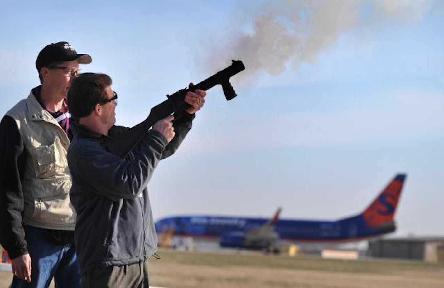 Jon Oesterreich demonstrated how to fire a pyrotechnic explosive round, designed to scare birds away, during a training session for MAC employees Thursday at Minneapolis-St. Paul International Airport.