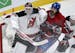 Montreal Canadiens right wing George Parros (15) is sandwiched between New Jersey Devils goalie Martin Brodeur (30) and Devils right wing Mike Sislo (