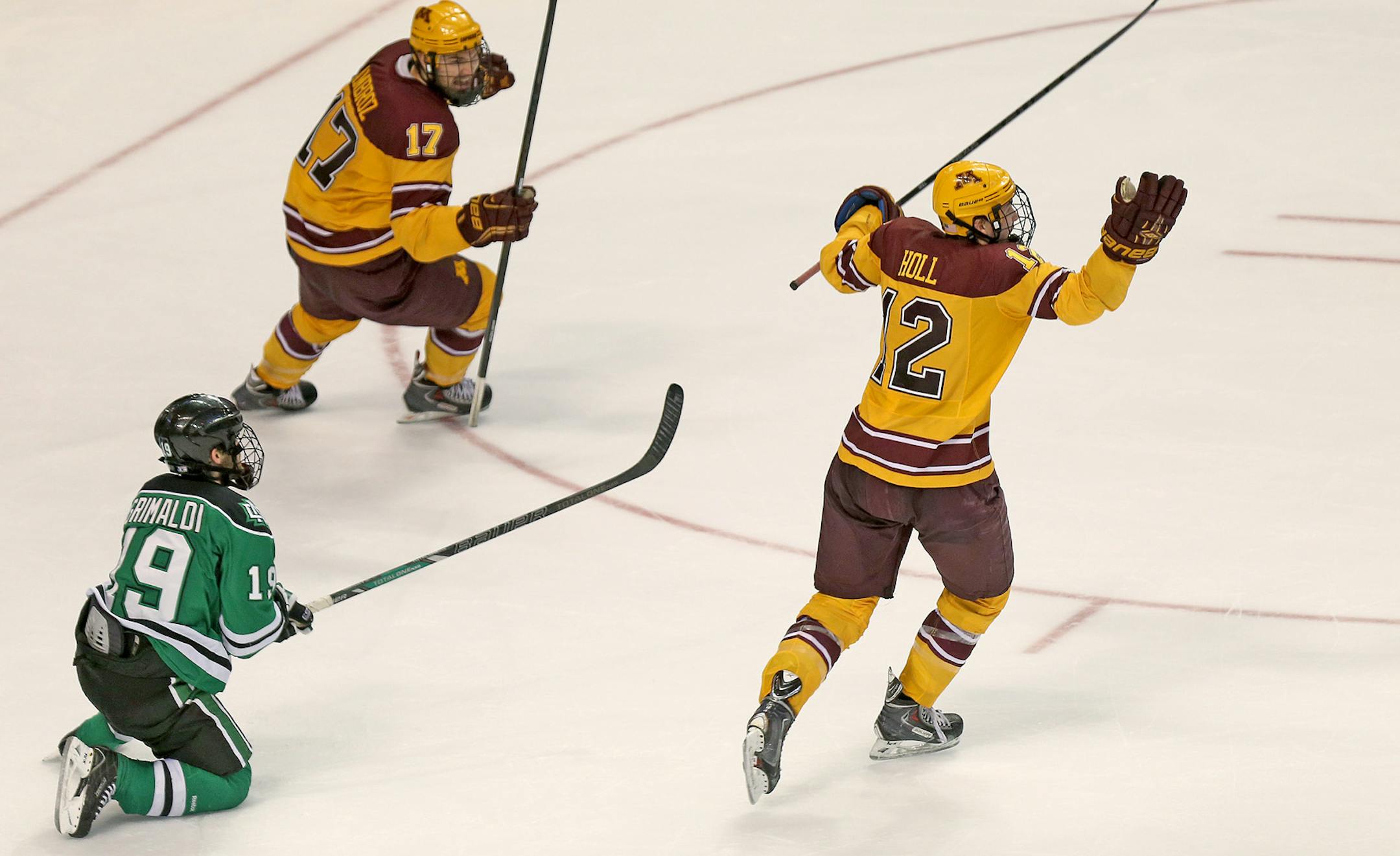 Minnesota Gophers Seth Ambroz, left, and Justin Holl celebrated the game winning goal with only .06 seconds left to defeat North Dakota during the third period of the Frozen Four at the Wells Fargo Center in Philadelphia, PA, Thursday, April 10, 2014. ] (ELIZABETH FLORES/STAR TRIBUNE) ELIZABETH FLORES • eflores@startribune.com