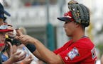 Minnesota Twins right fielder Alex Kirilloff signs autographs before the start of inning of a spring training baseball game against the Baltimore Orio
